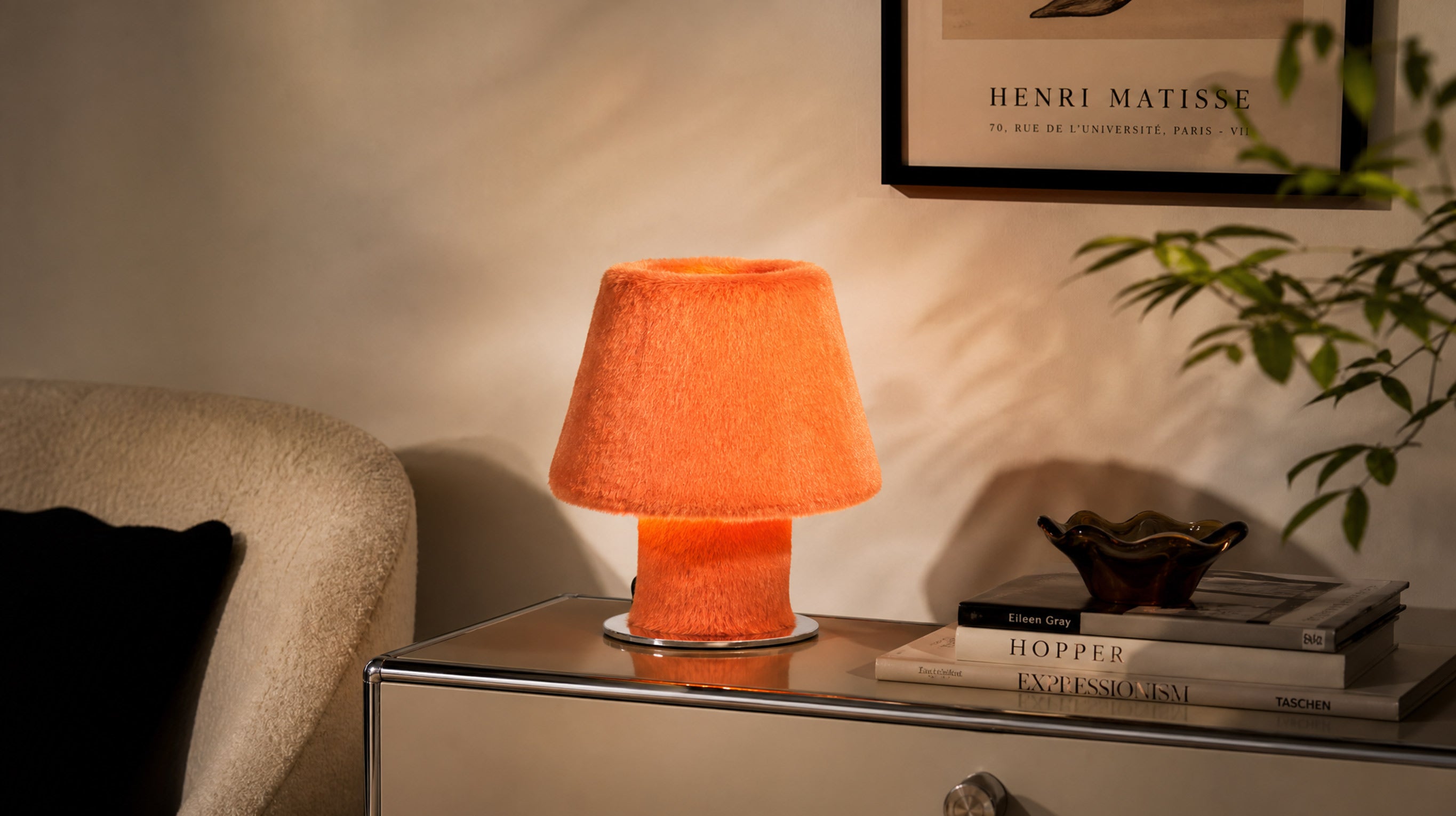 The ARTAMORE 36.5°C plush table lamp illuminating a warm minimalist bedroom with its modern organic design and comforting glow.