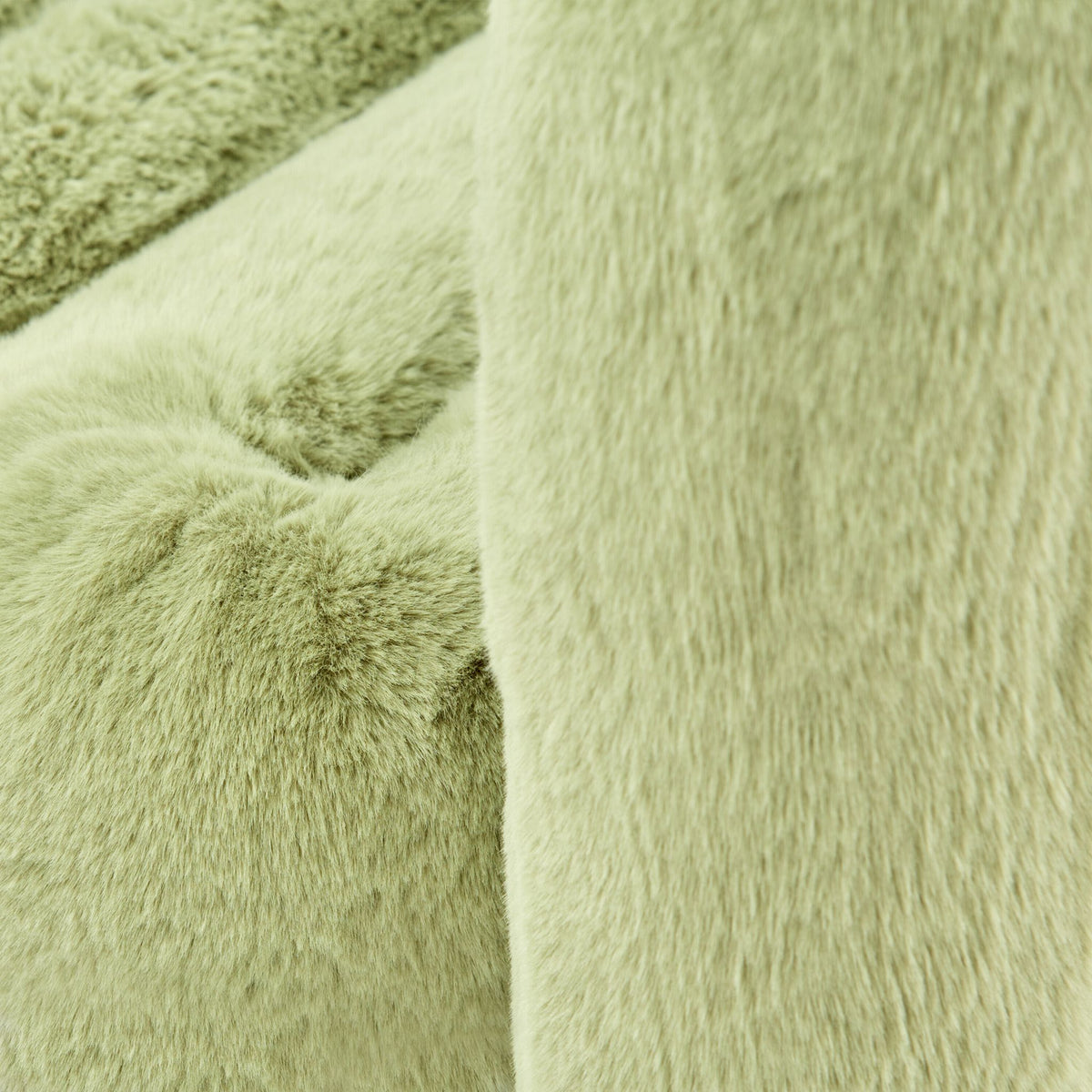 Close-up of avocado green eco-fur upholstery on the 36.5°C Series large lounge chair showing its soft plush texture