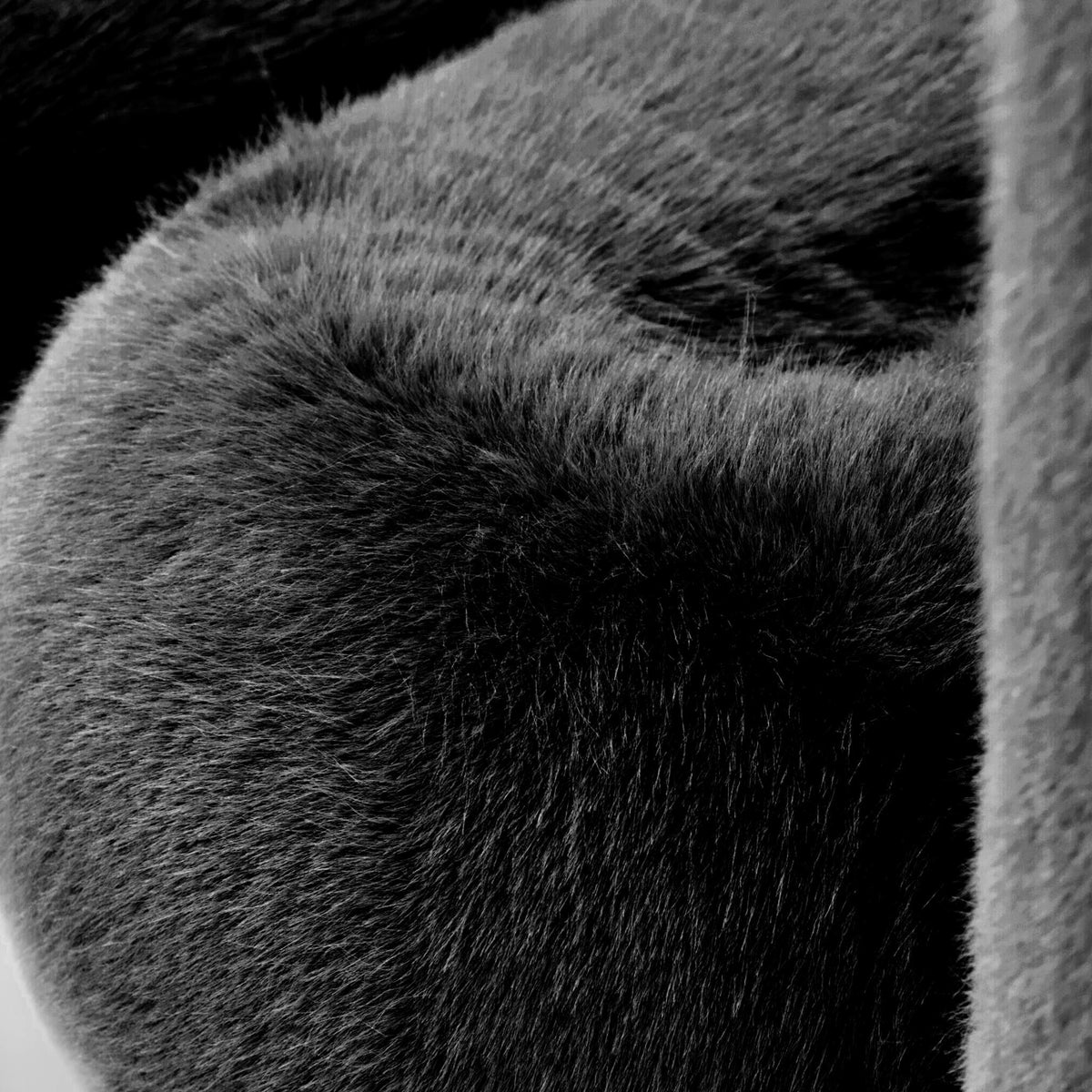 Close-up of black eco-fur upholstery on the 36.5°C Series large lounge chair showing its dense plush texture