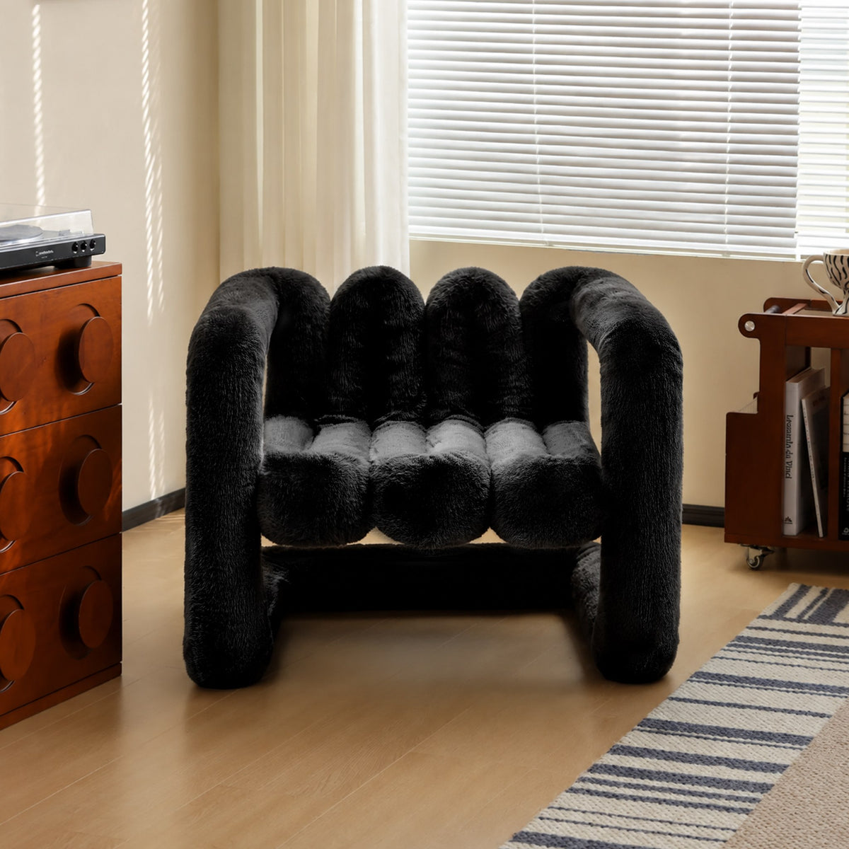 Black 36.5°C Series large sculptural eco-fur lounge chair with plush channelled seat and rounded frame