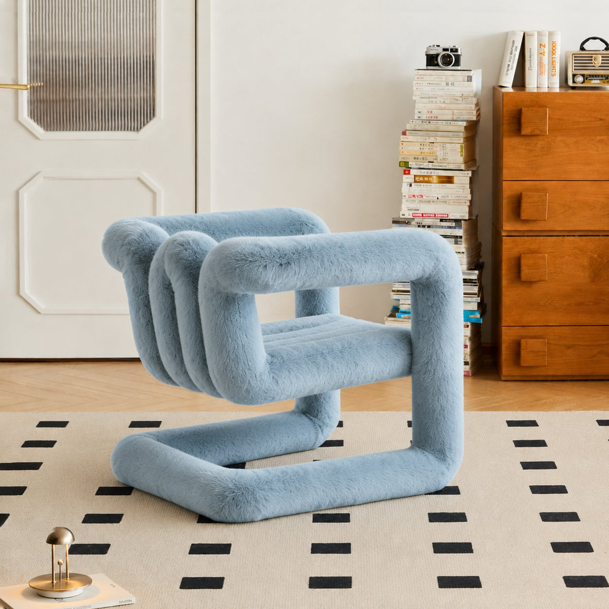Angled view of the light blue 36.5°C Series eco-fur lounge chair with sculptural cantilevered frame