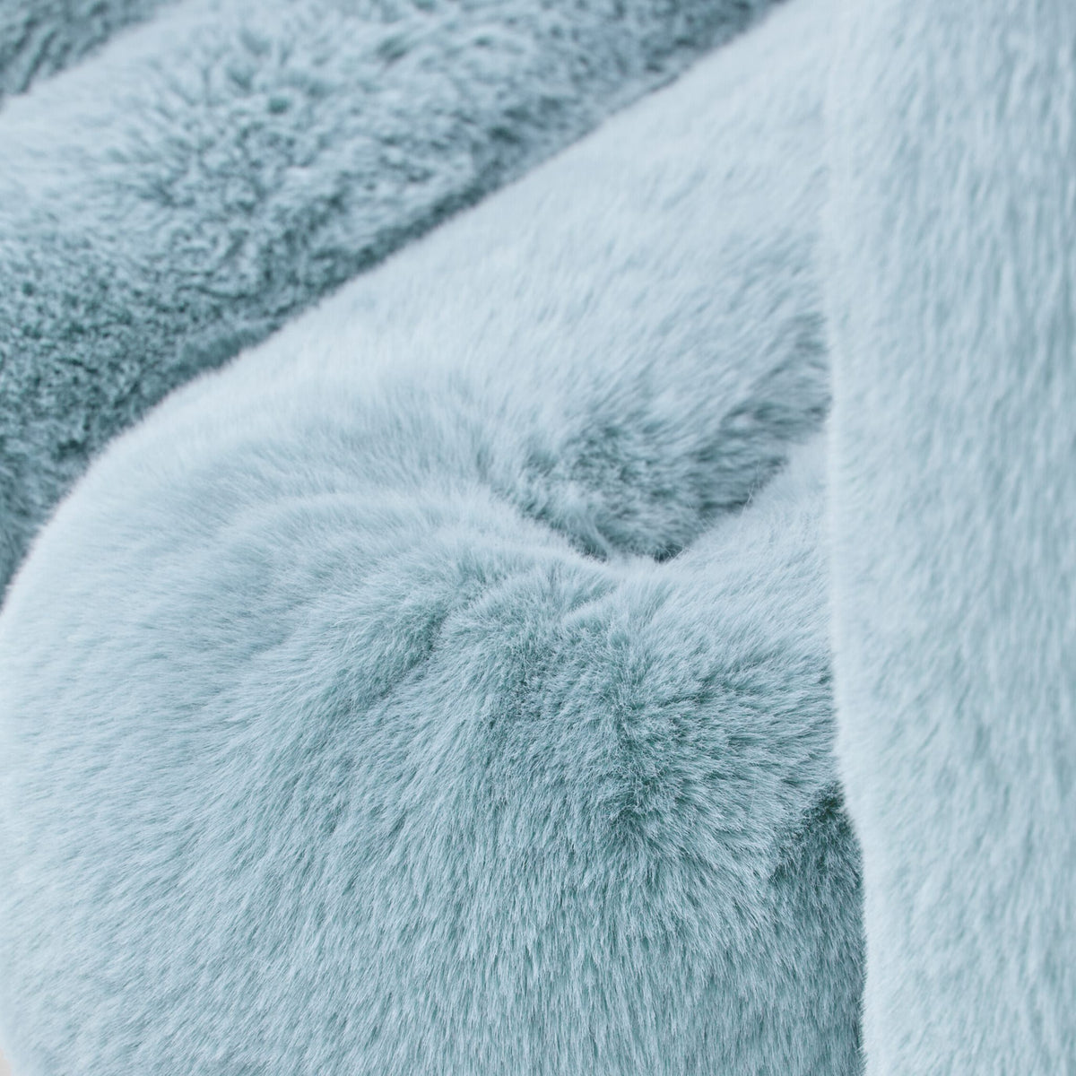 Close-up of light blue eco-fur upholstery on the 36.5°C Series large lounge chair showing its soft plush texture