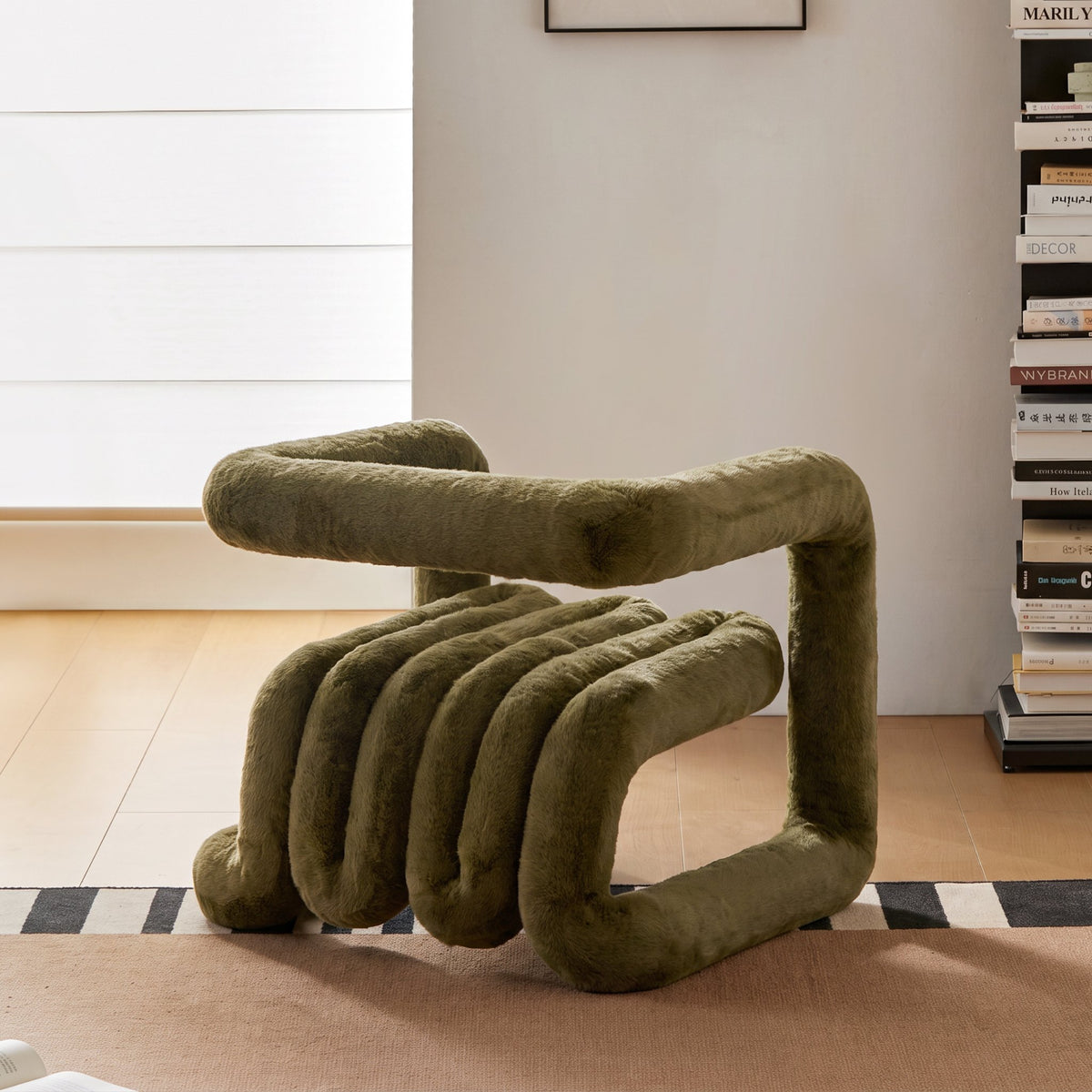 Side angled view of the olive green 36.5°C Series plush lounge chair with flowing cantilevered structure