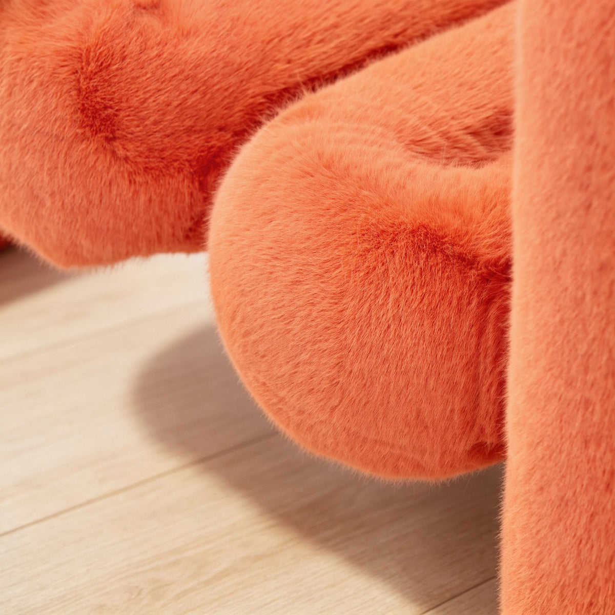 Close-up of orange eco-fur upholstery on the 36.5°C Series large lounge chair showing its soft dense plush texture