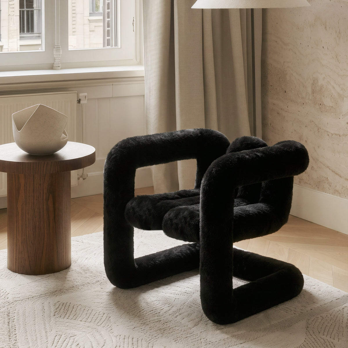 Three-quarter view of the black 36.5°C Series Medium-L sculptural chair with soft eco-fur upholstery and rounded proportions