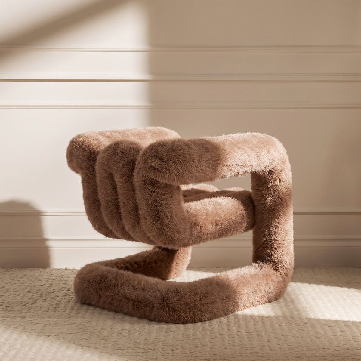 Side view of the brown 36.5°C Series Medium-L sculptural chair showing its cantilevered looped frame and plush upholstery
