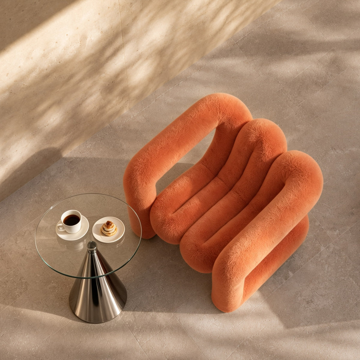 Top view of the orange 36.5°C Series Medium-L plush chair beside a glass side table in a contemporary interior