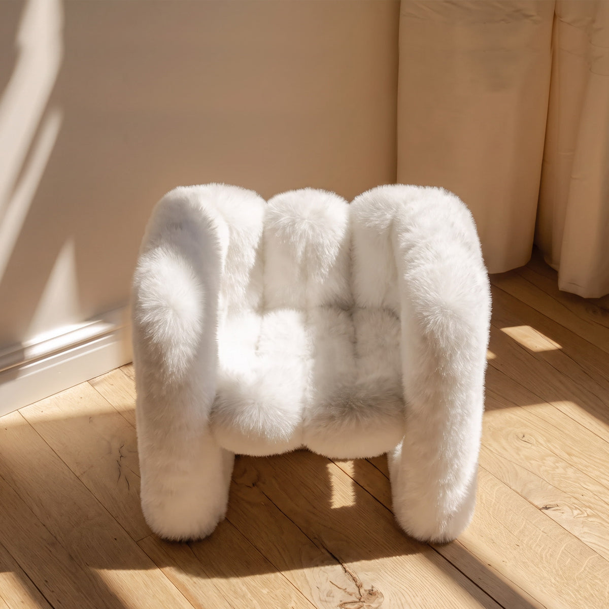 Front angled view of the white 36.5°C Series Medium-L sculptural chair showing its soft rounded seat and looped frame