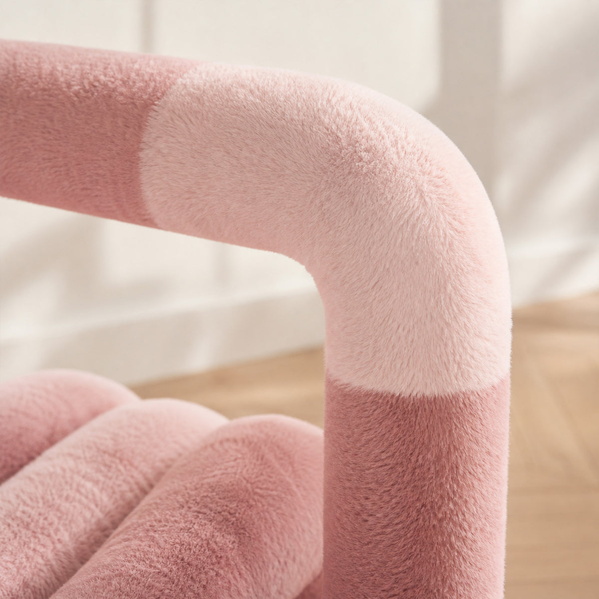 Close-up of the pink 36.5°C Series Medium Chair highlighting the soft layered eco-fur upholstery on its rounded frame