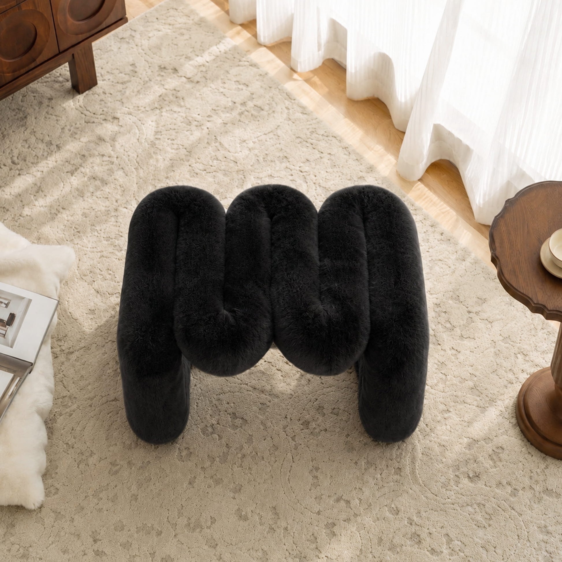 Top view of the black 36.5°C Series Plush Stool showing its reversible sculptural configuration.