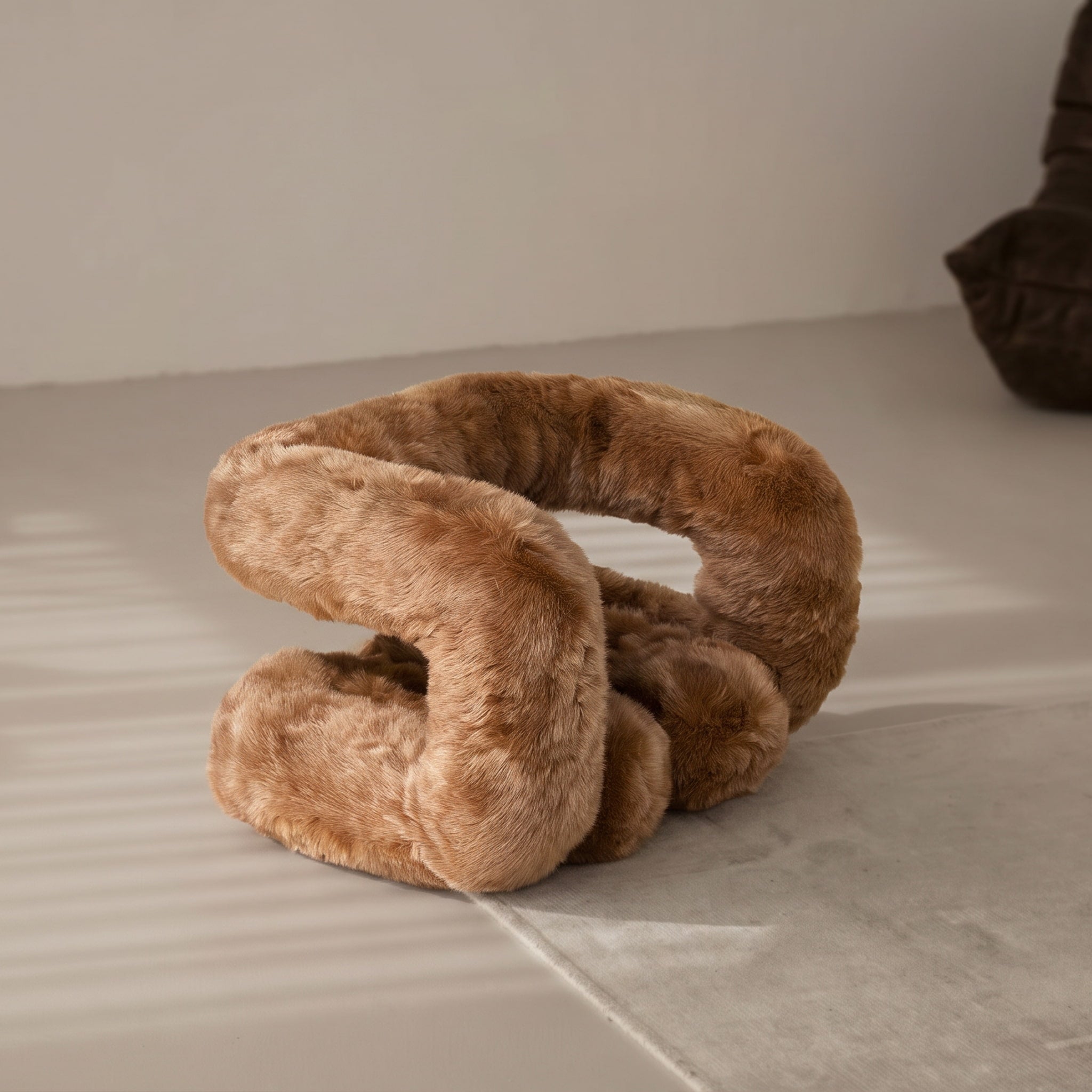 Camel brown 36.5°C Series Plush Stool displayed as soft sculptural furniture in a minimalist interior.