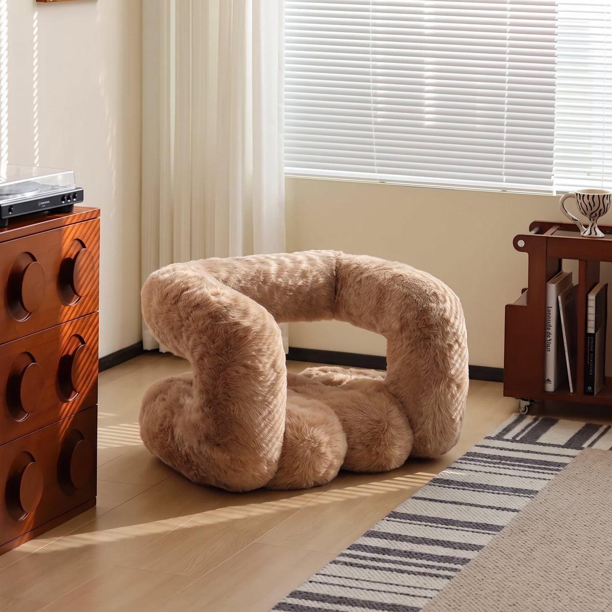 Camel brown 36.5°C Series Plush Stool styled in a sunlit modern room with warm wood furniture.