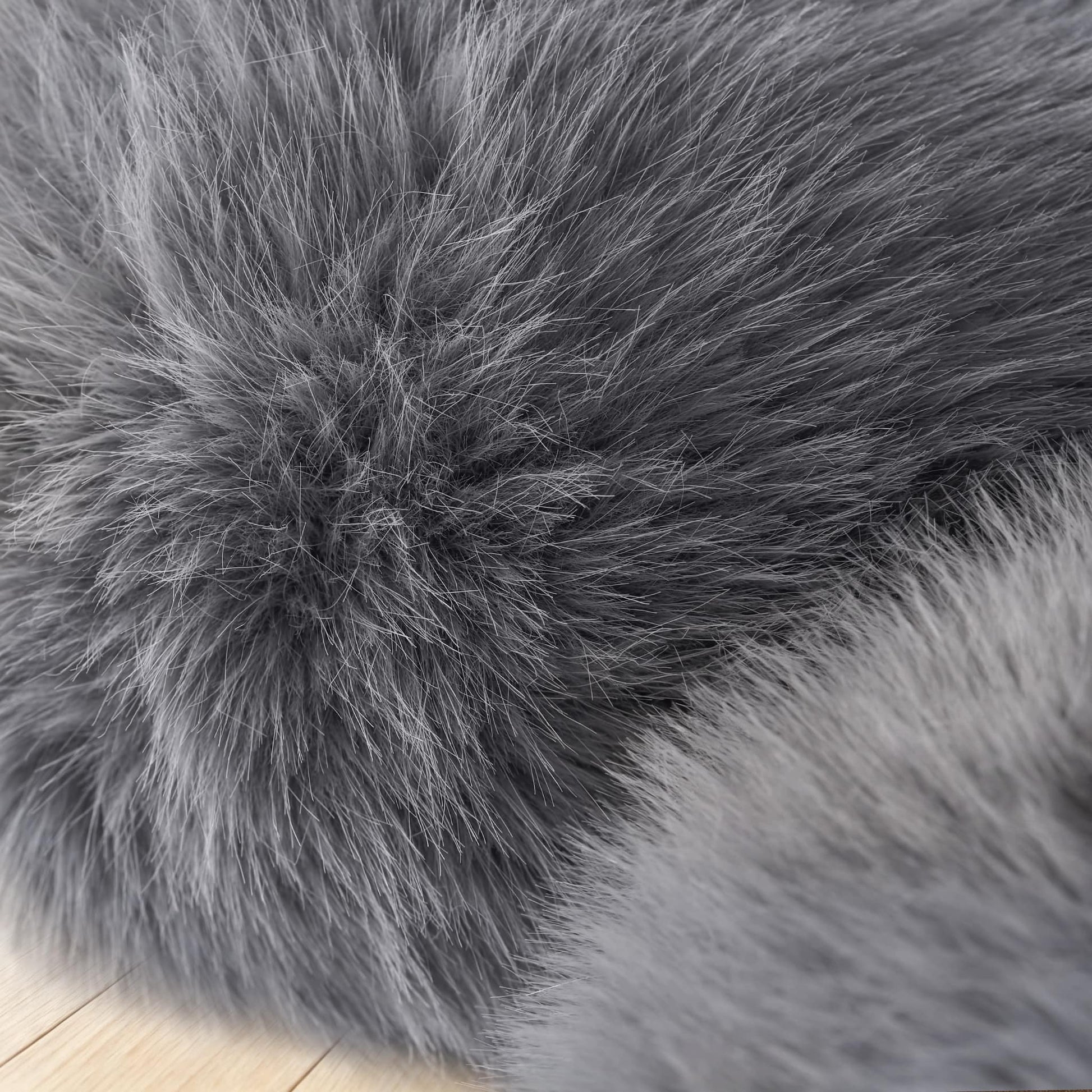 Close-up of the soft charcoal gray eco-fur upholstery on the 36.5°C Series Plush Stool.