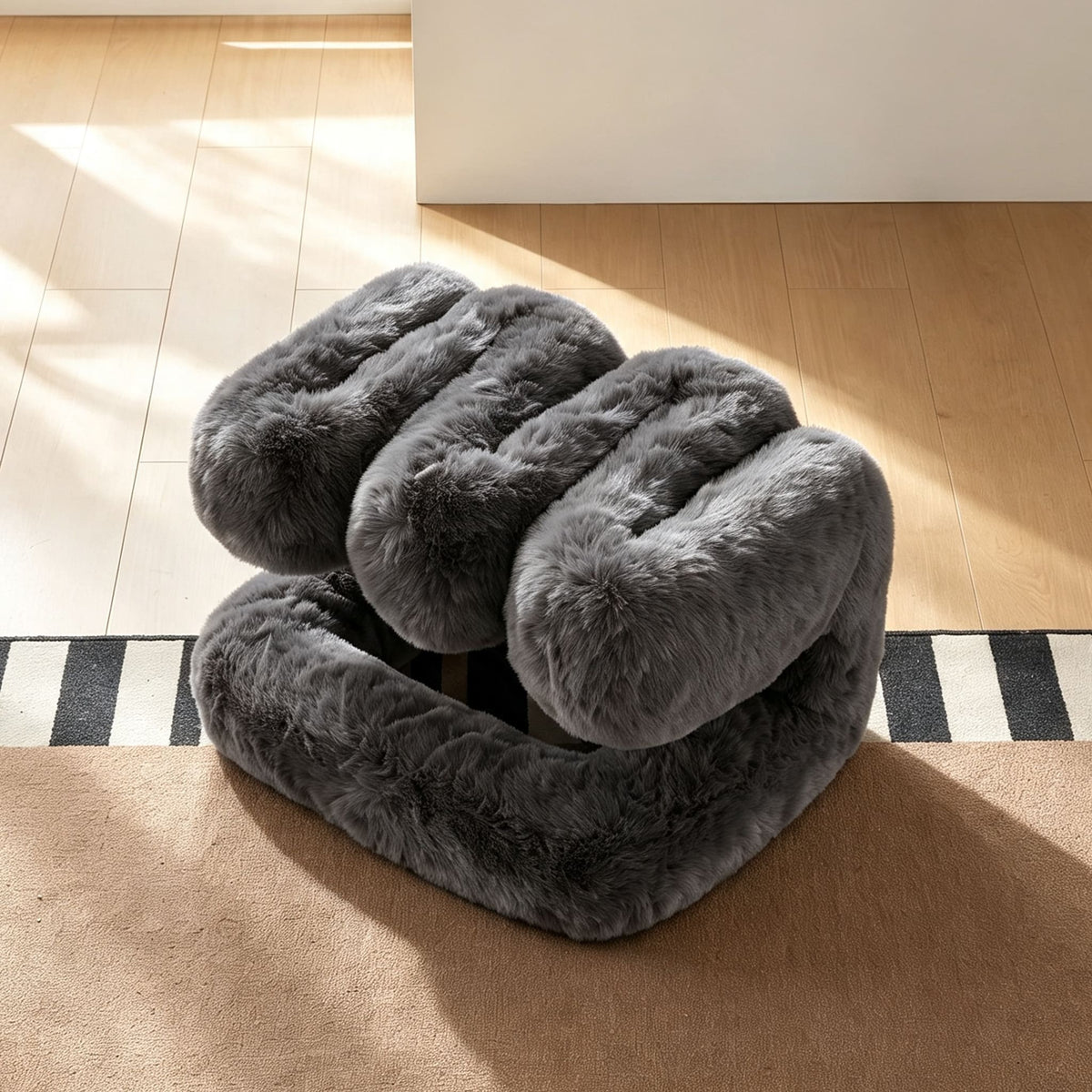 Charcoal gray 36.5°C Series Plush Stool shown in a reversed configuration highlighting its sculptural structure.