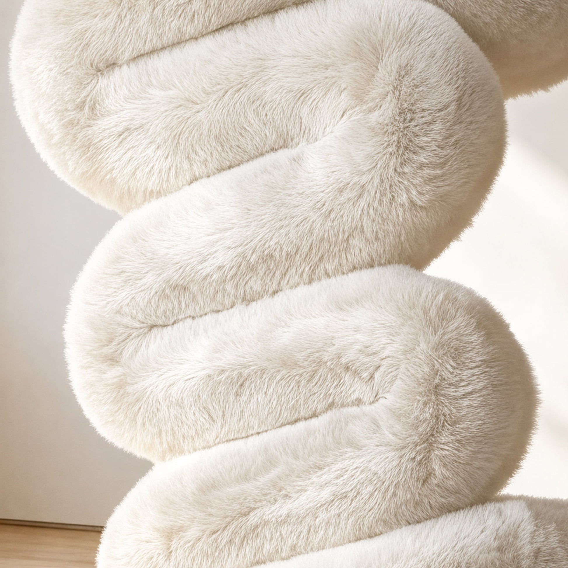 Close-up of the soft eco-fur upholstery and rounded cushioning of the white 36.5°C Series Plush Stool.