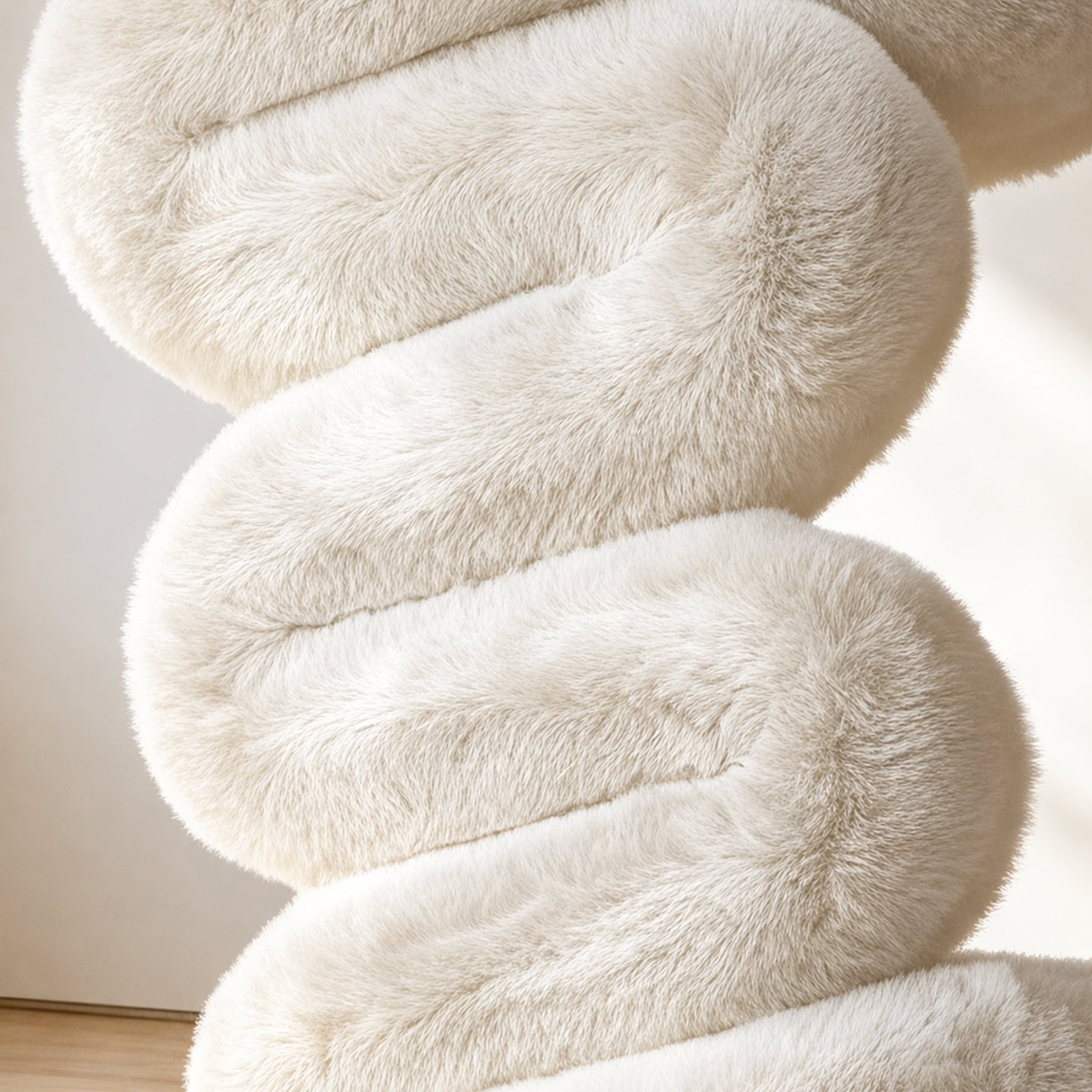 Close-up of the soft eco-fur upholstery and rounded cushioning of the white 36.5°C Series Plush Stool.