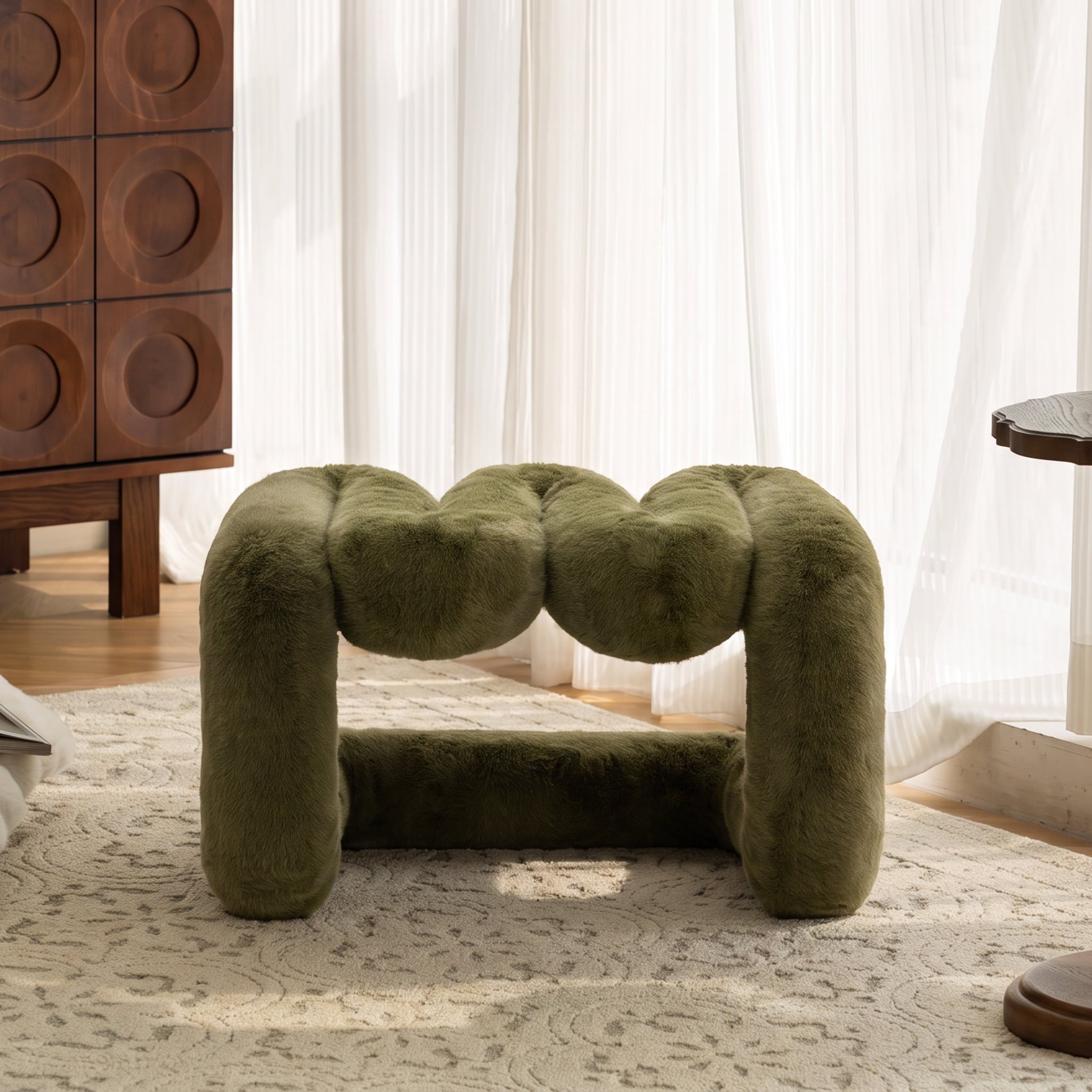 Front view of the olive green 36.5°C Series Plush Stool showing its rounded wave-like form in a sunlit contemporary interior.
