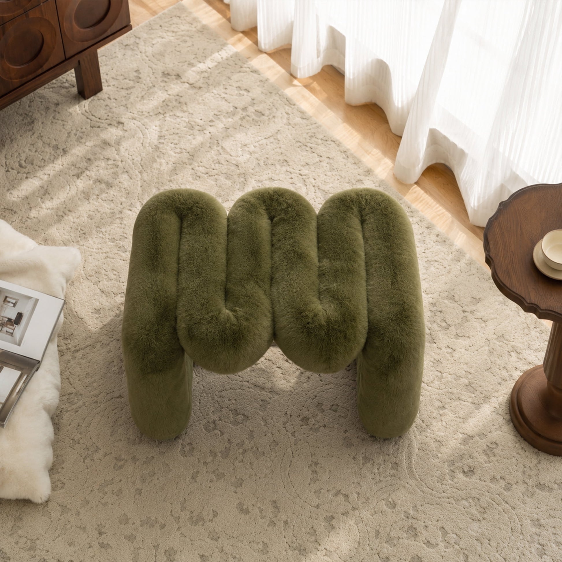Overhead view of the olive green 36.5°C Series Plush Stool highlighting its rounded cushions and wave-like sculptural silhouette.