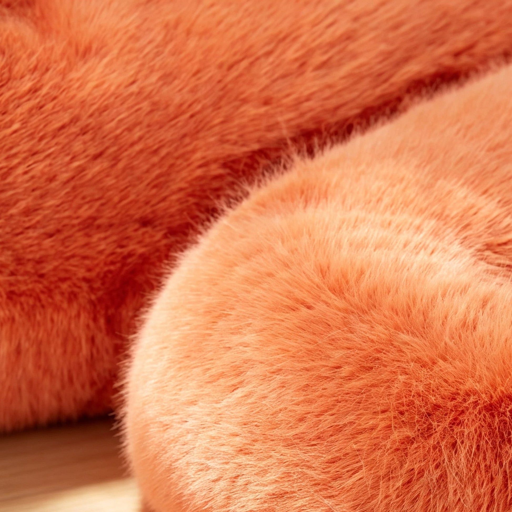 Close-up of the soft orange eco-fur upholstery and plush texture of the 36.5°C Series Stool.