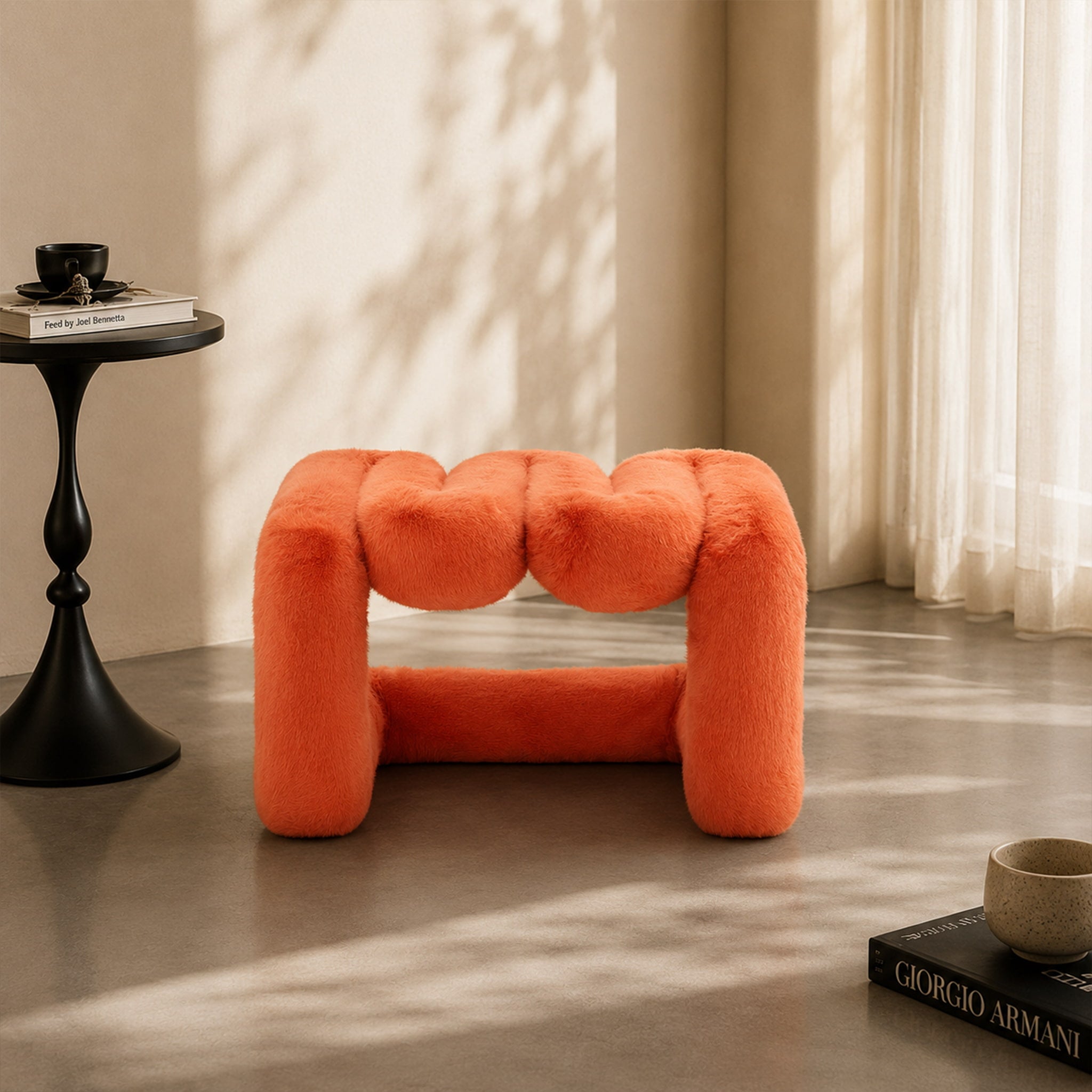 Front view of the orange 36.5°C Series Plush Stool highlighting its rounded sculptural form.