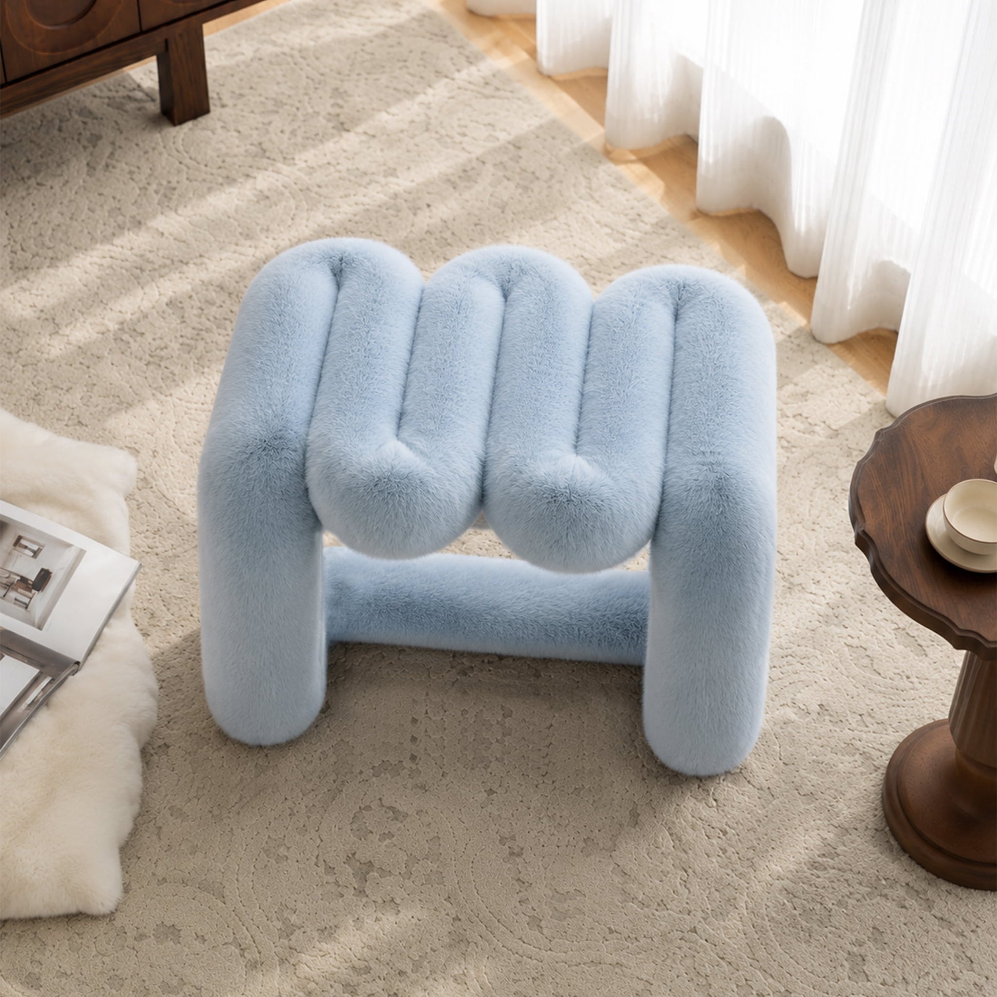 Elevated view of the powder blue 36.5°C Series Plush Stool highlighting its rounded wave-like design.