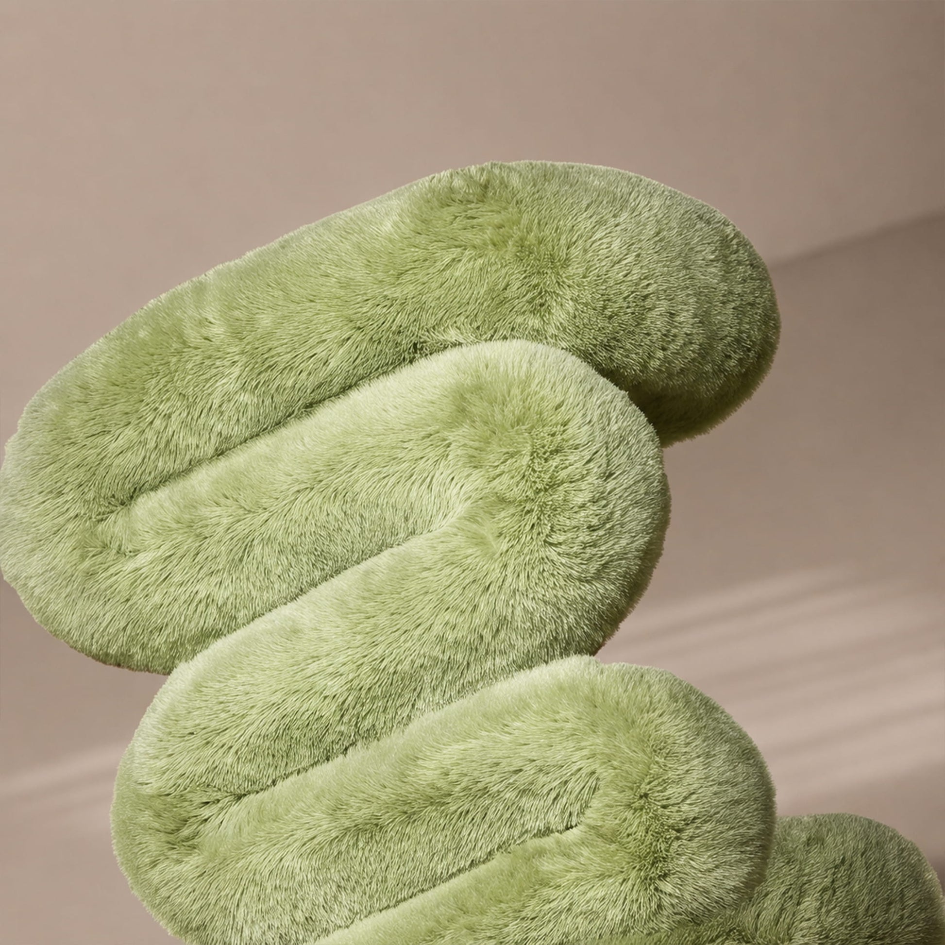 Close-up of the sage green 36.5°C Series Plush Stool showing its rounded form and soft eco-fur texture.