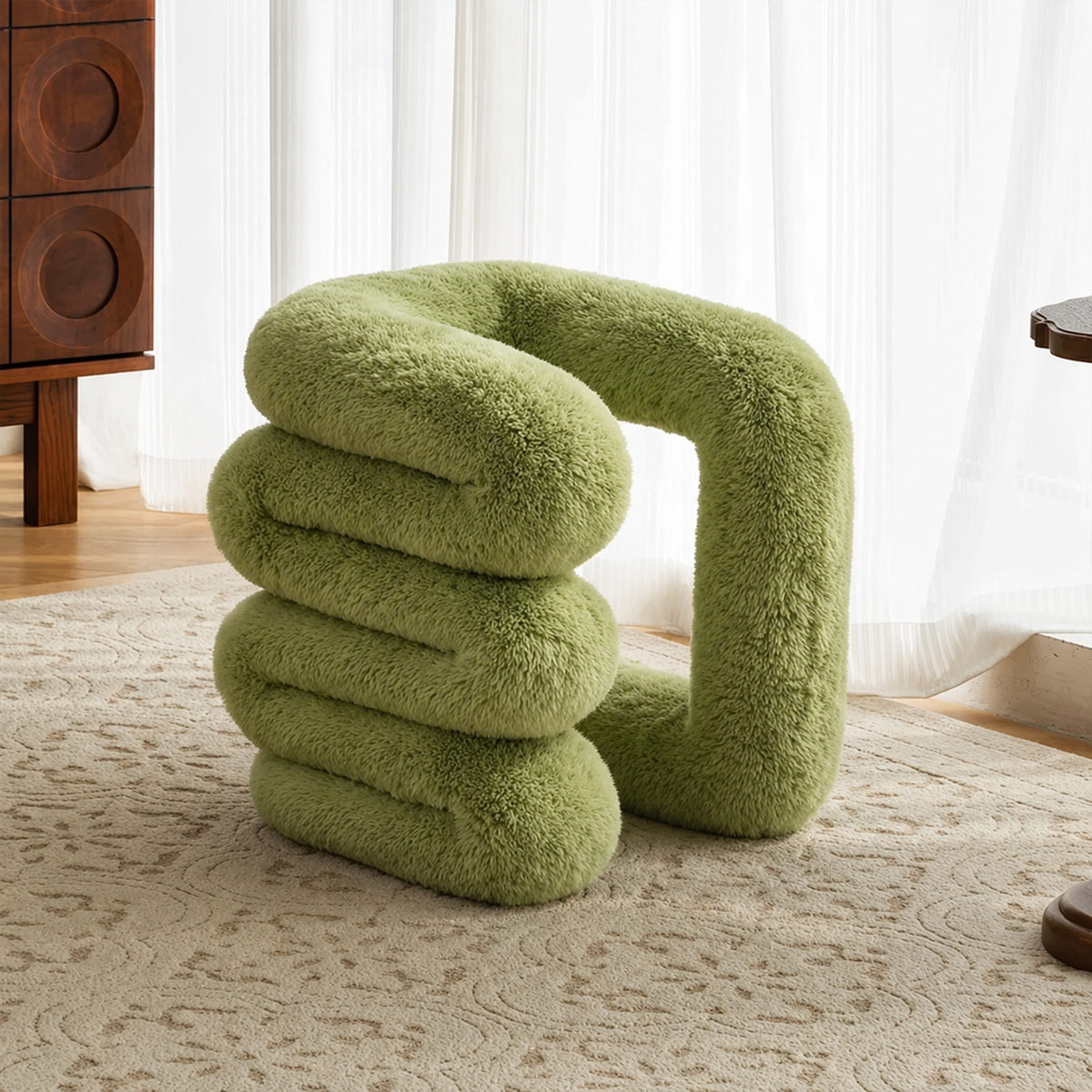 Side profile of the sage green 36.5°C Series Plush Stool highlighting its stacked wave-like sculptural form.