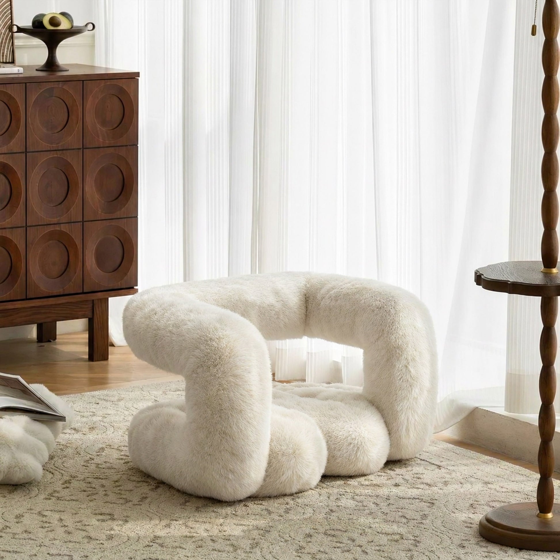 White eco-fur 36.5°C Series Plush Stool in a warm modern interior with wood furniture and sheer curtains.