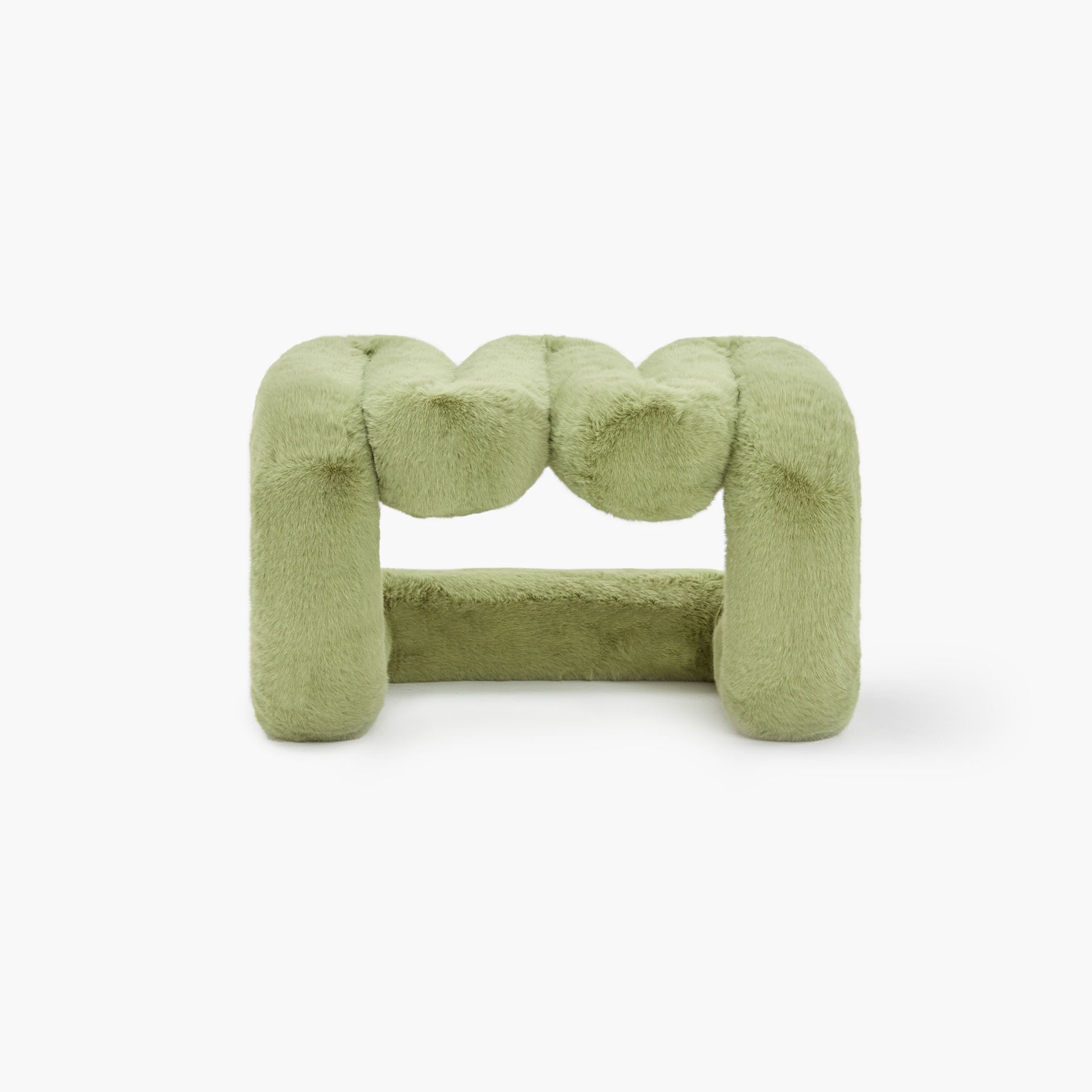 Contemporary green eco-fur lounge stool in minimalist space