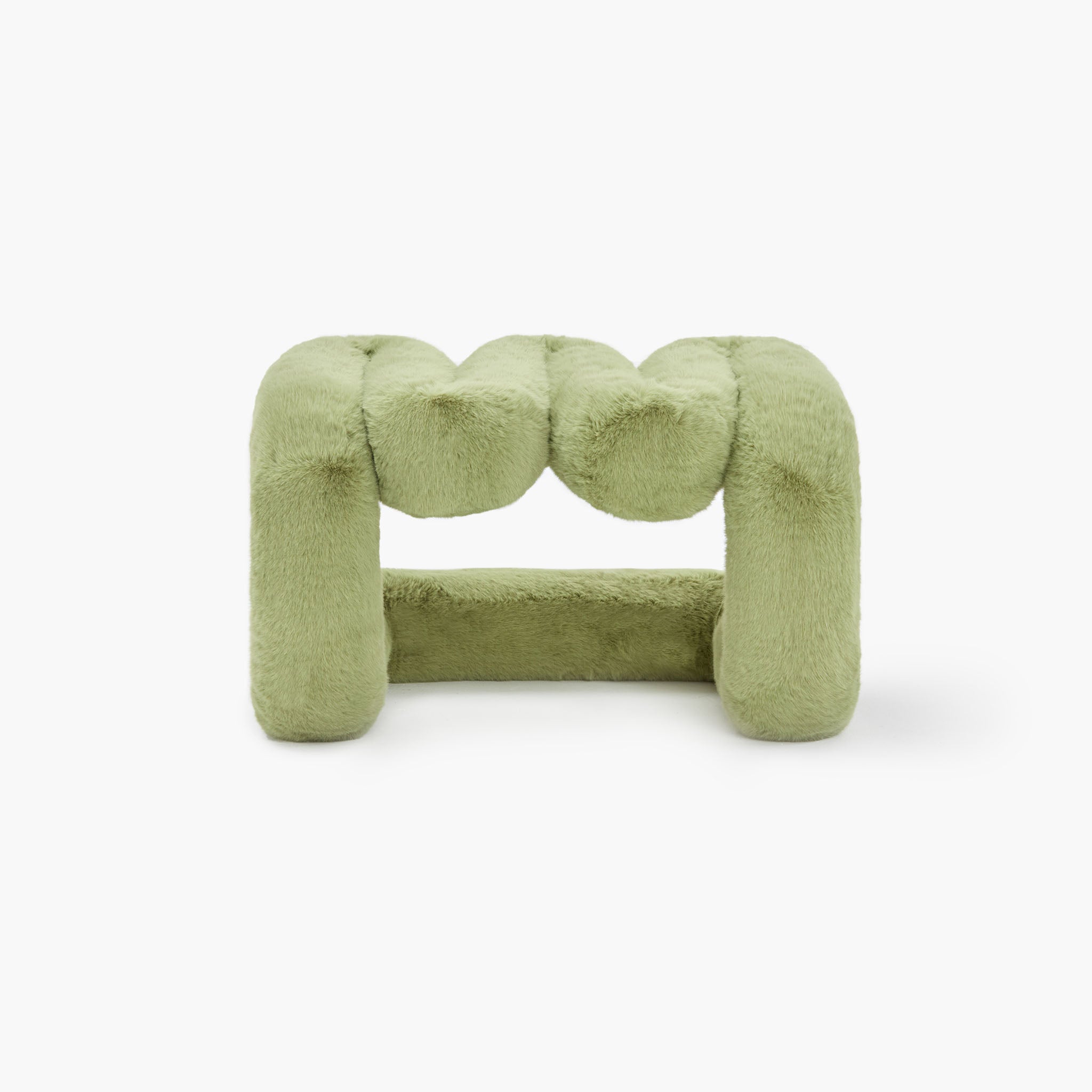 Contemporary green eco-fur lounge stool in minimalist space