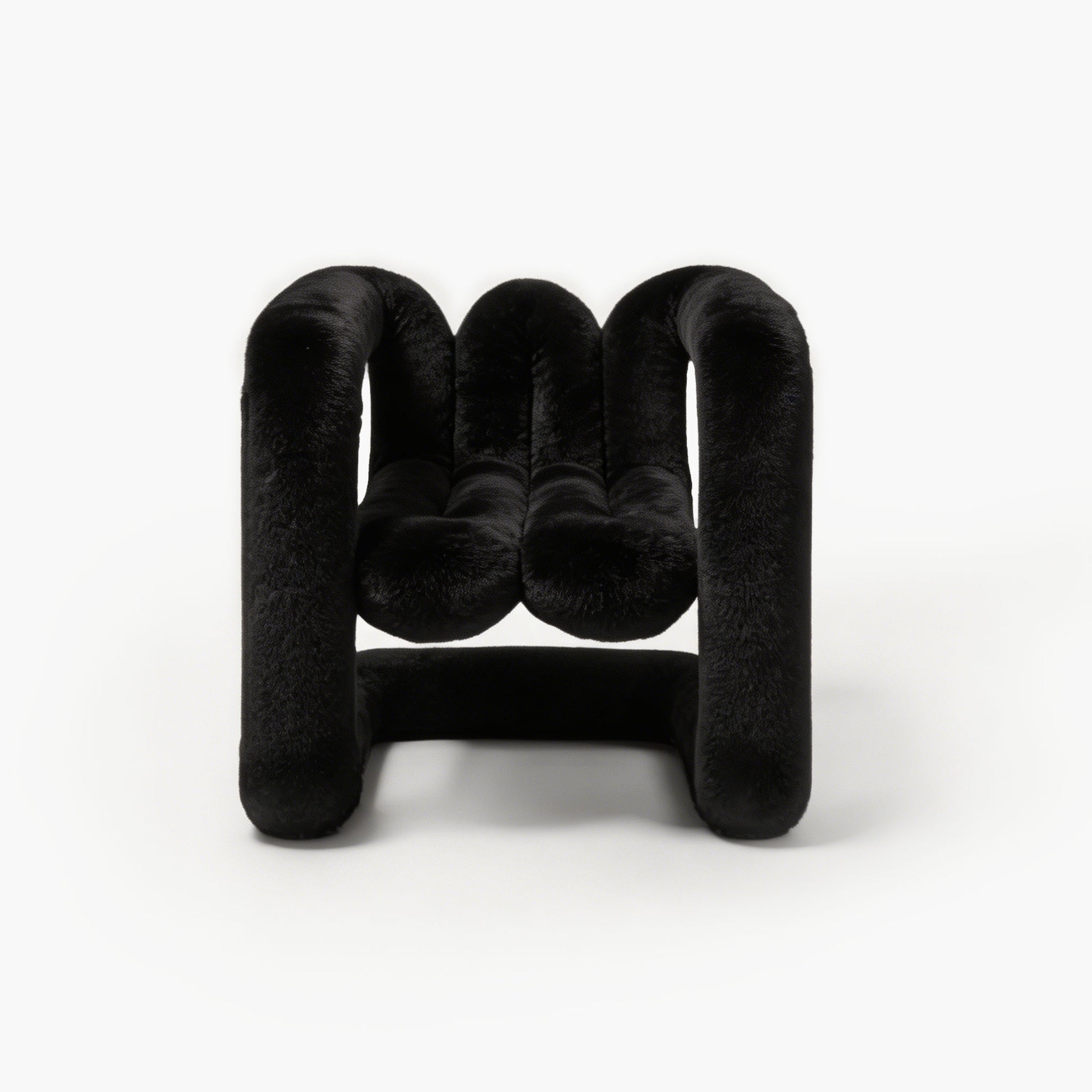 Midnight black sculptural eco-fur accent chair with a rounded silhouette