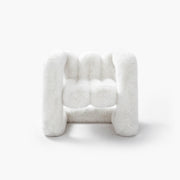 Snowy white plush eco-fur lounge chair with a rounded silhouette