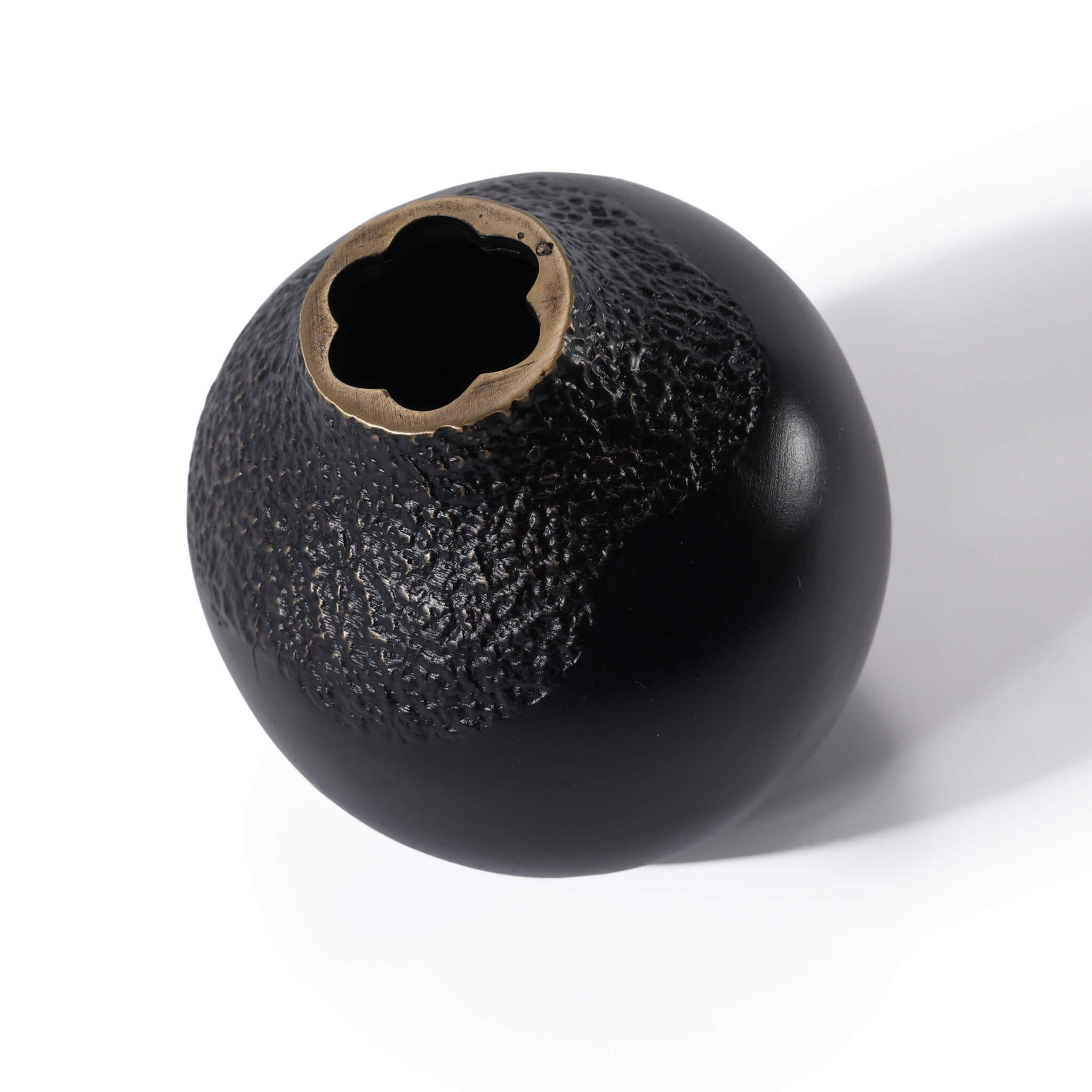 Top-down angled view of the black solid brass acorn vase, showcasing its unique handcrafted opening and sculptural form