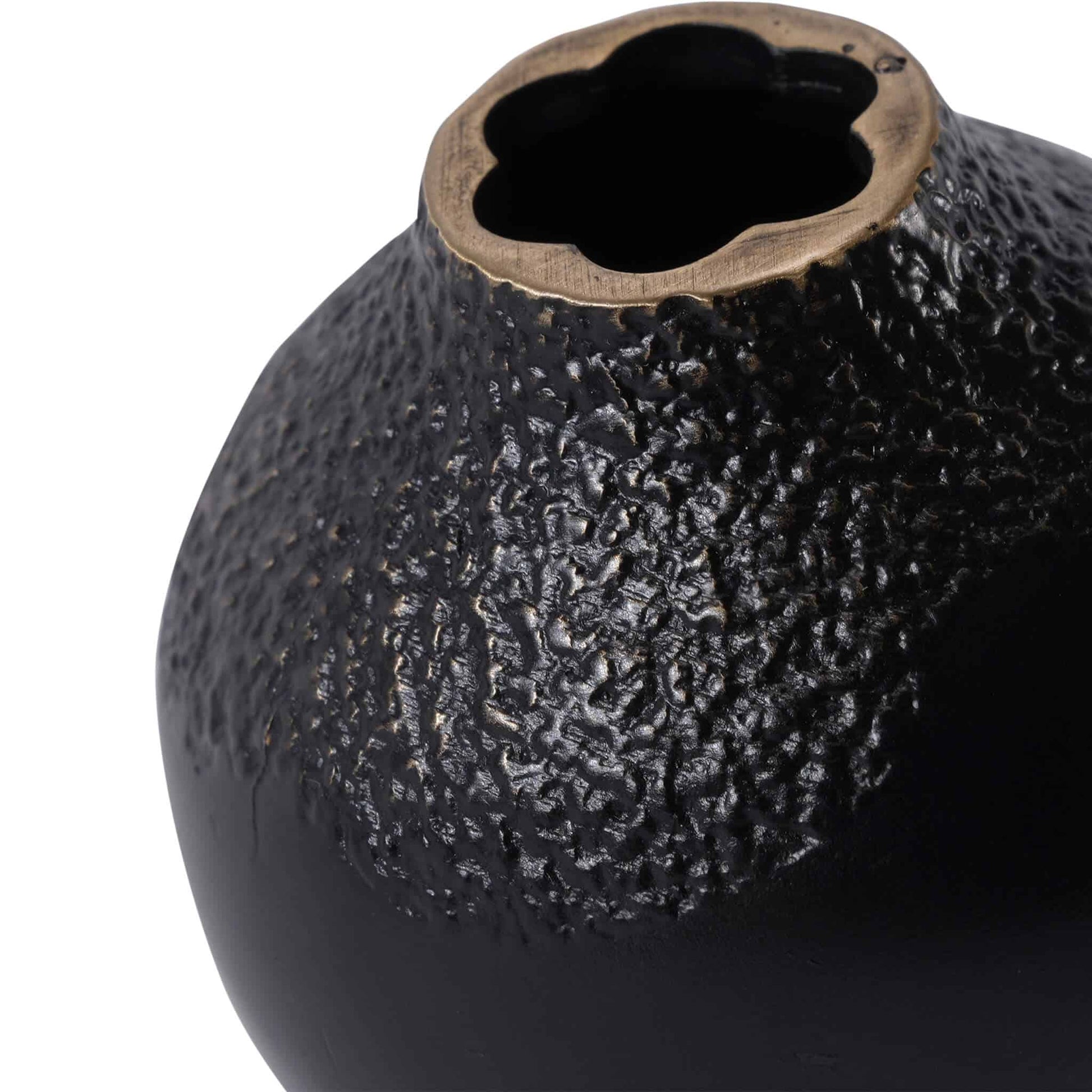 Close-up of the handcrafted miniature bud vase, showing the irregular petal-shaped rim and textured brass pigmentation finish