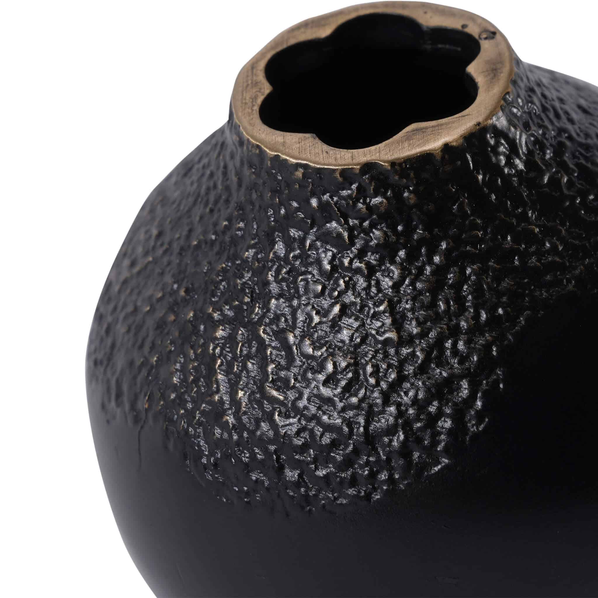 Close-up of the handcrafted miniature bud vase, showing the irregular petal-shaped rim and textured brass pigmentation finish