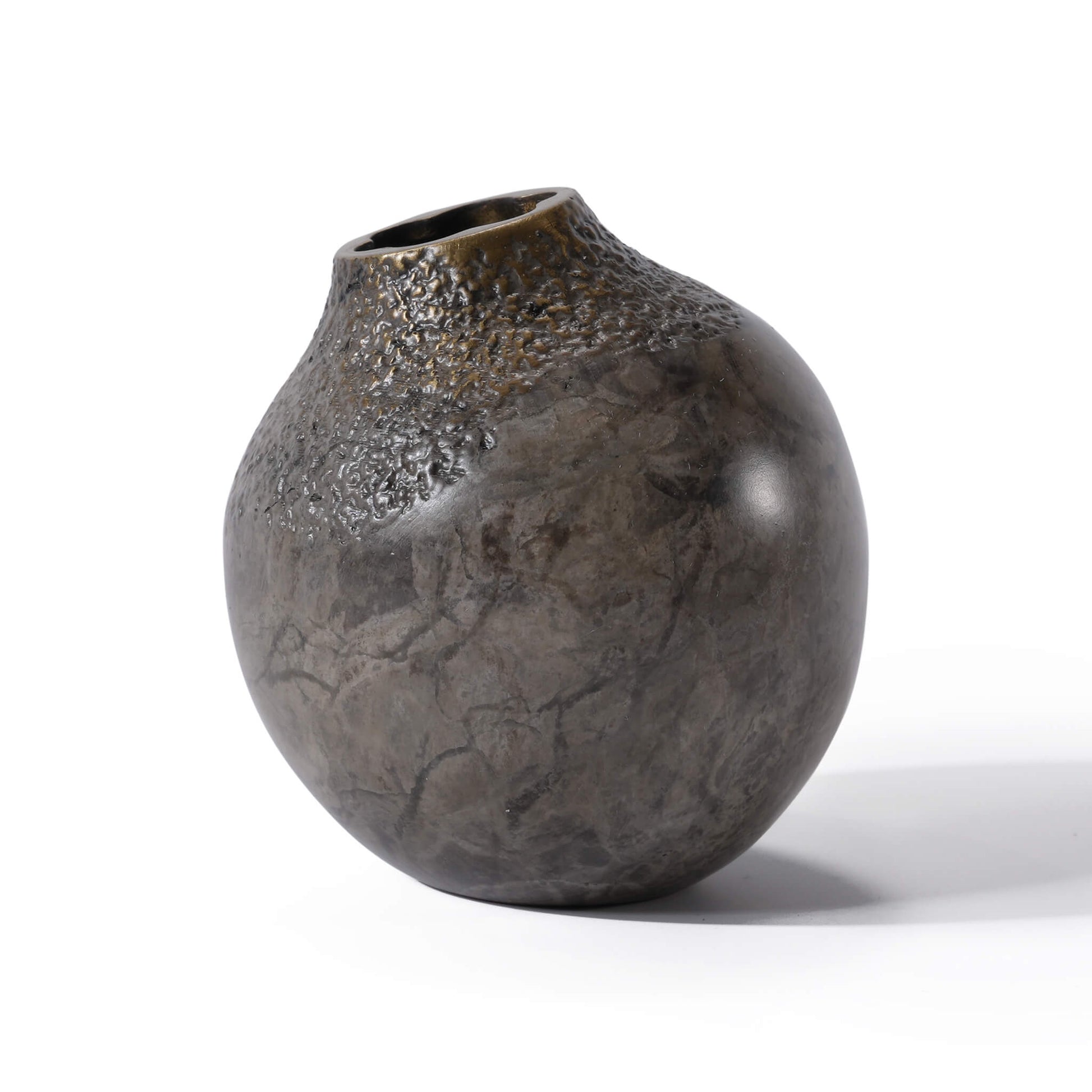 Angled view of the miniature solid brass bud vase, highlighting the unique artisan wabi-sabi texture and metallic finish