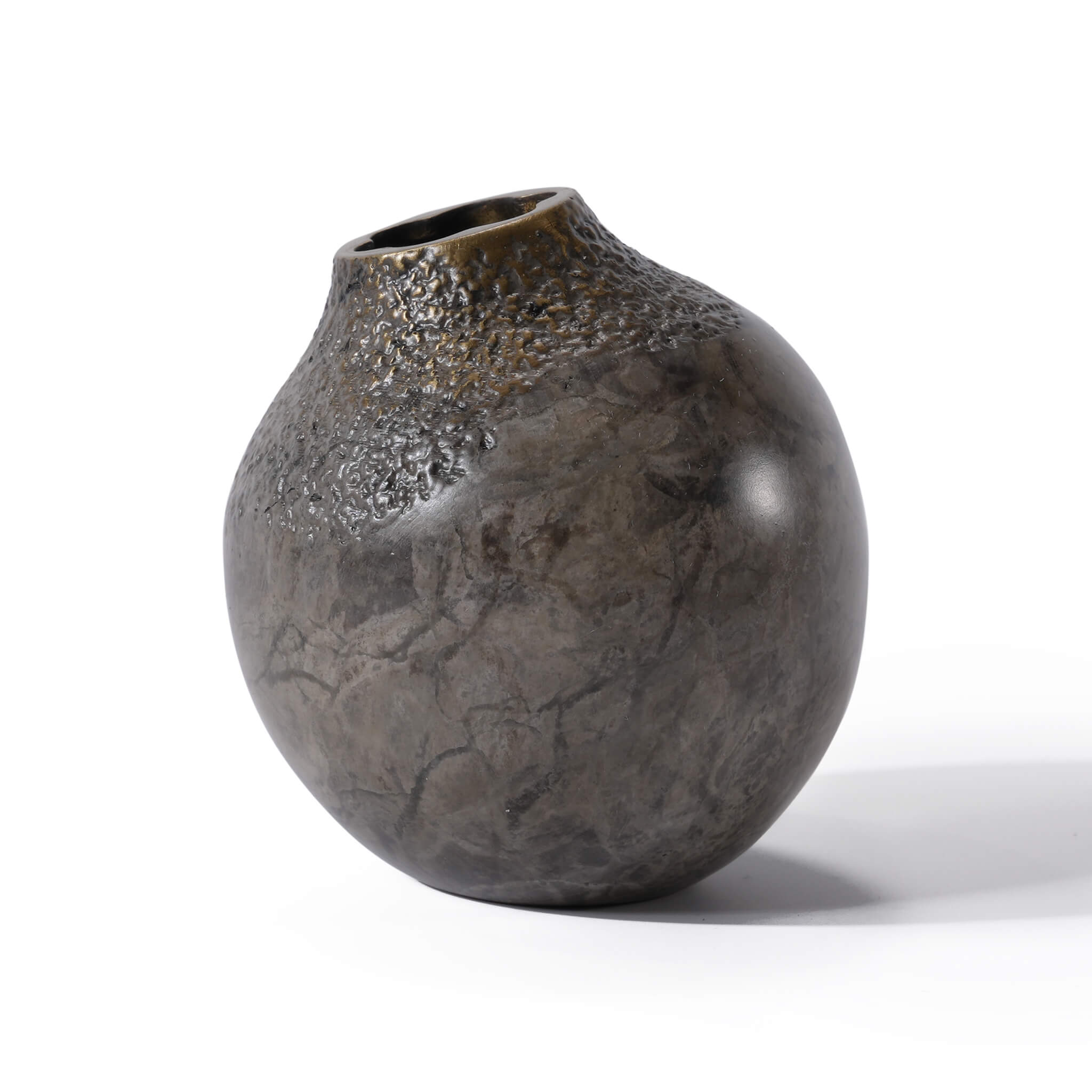 Angled view of the miniature solid brass bud vase, highlighting the unique artisan wabi-sabi texture and metallic finish