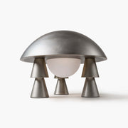 Cordless cast aluminum table lamp with glowing frosted glass shade