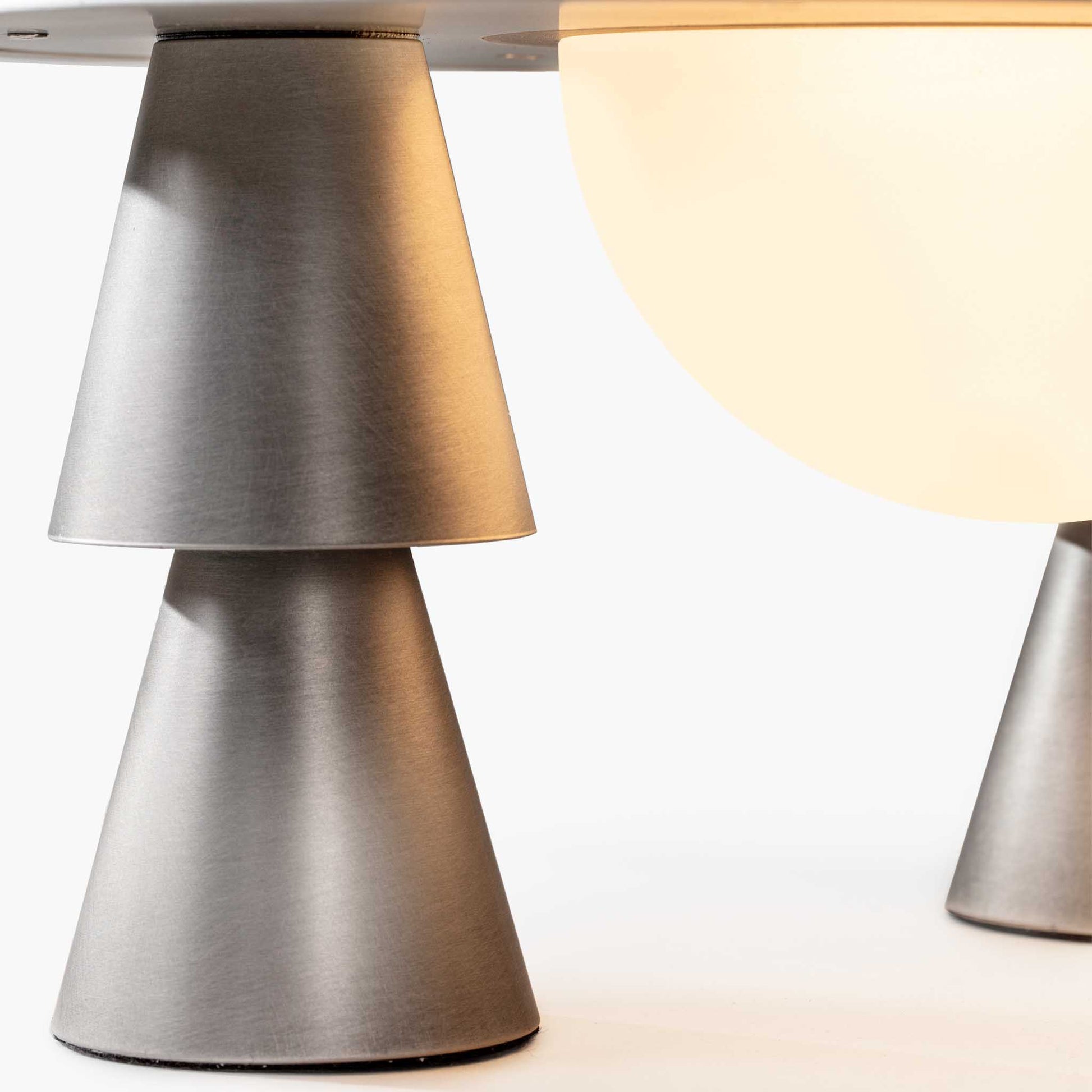 Detail of the tiered conical legs and premium aged aluminum finish