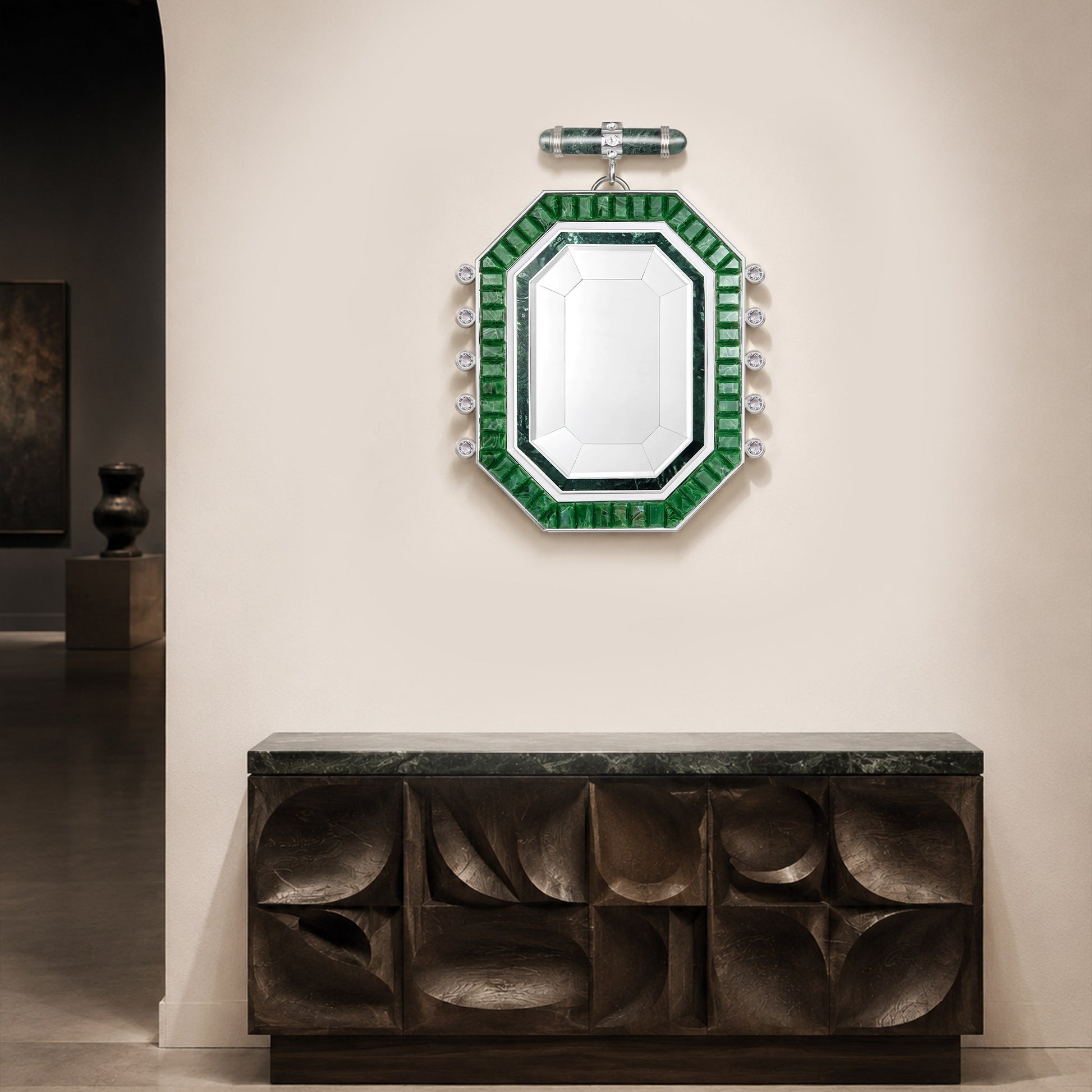 Artamore Art Deco emerald wall mirror displayed above a sculptural console cabinet.