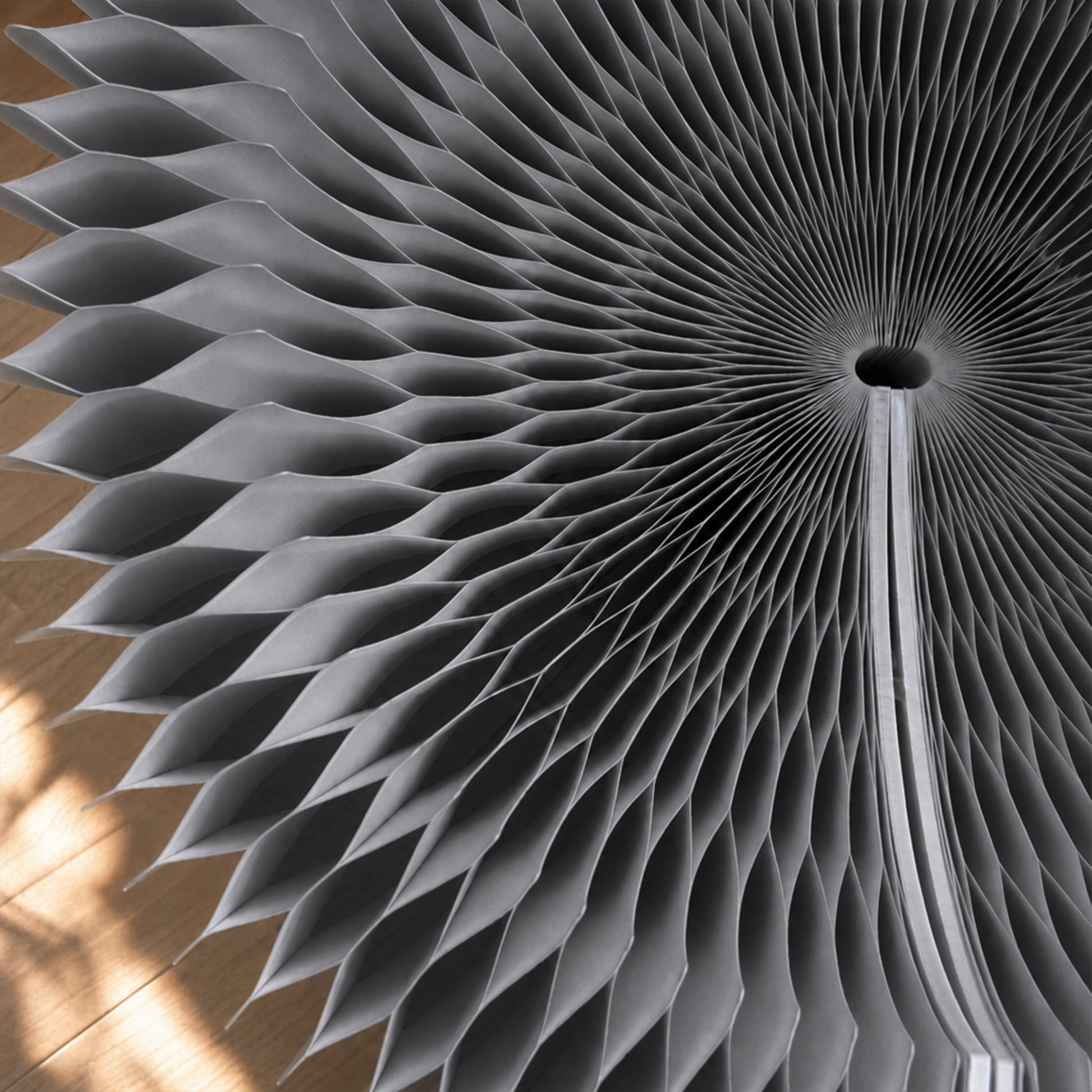 Close-up of the grey Bouquet Side Table B showing the layered hexagonal honeycomb paper structure.