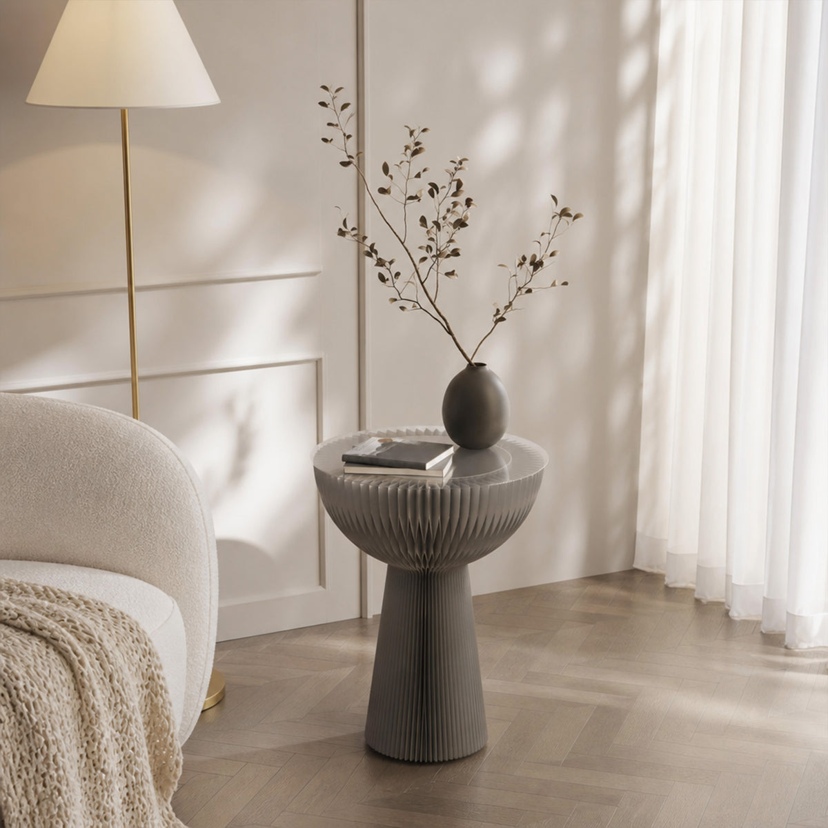 Grey Bouquet Side Table B styled with books and a vase in a softly lit modern living room.