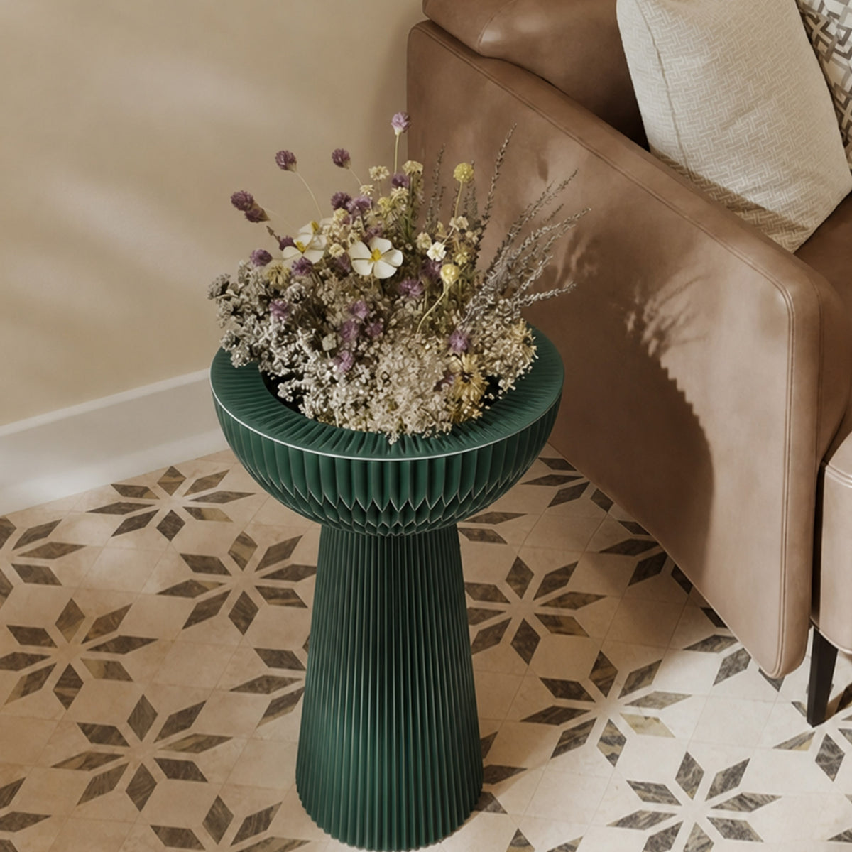 Pine green Bouquet Side Table B styled with a floral arrangement beside a leather sofa.