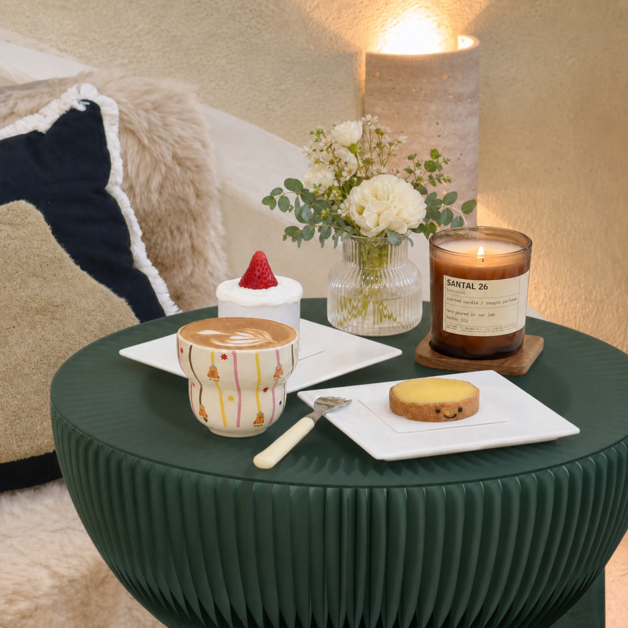 Pine green Bouquet Side Table B styled with coffee, flowers and a candle in a cozy living room.