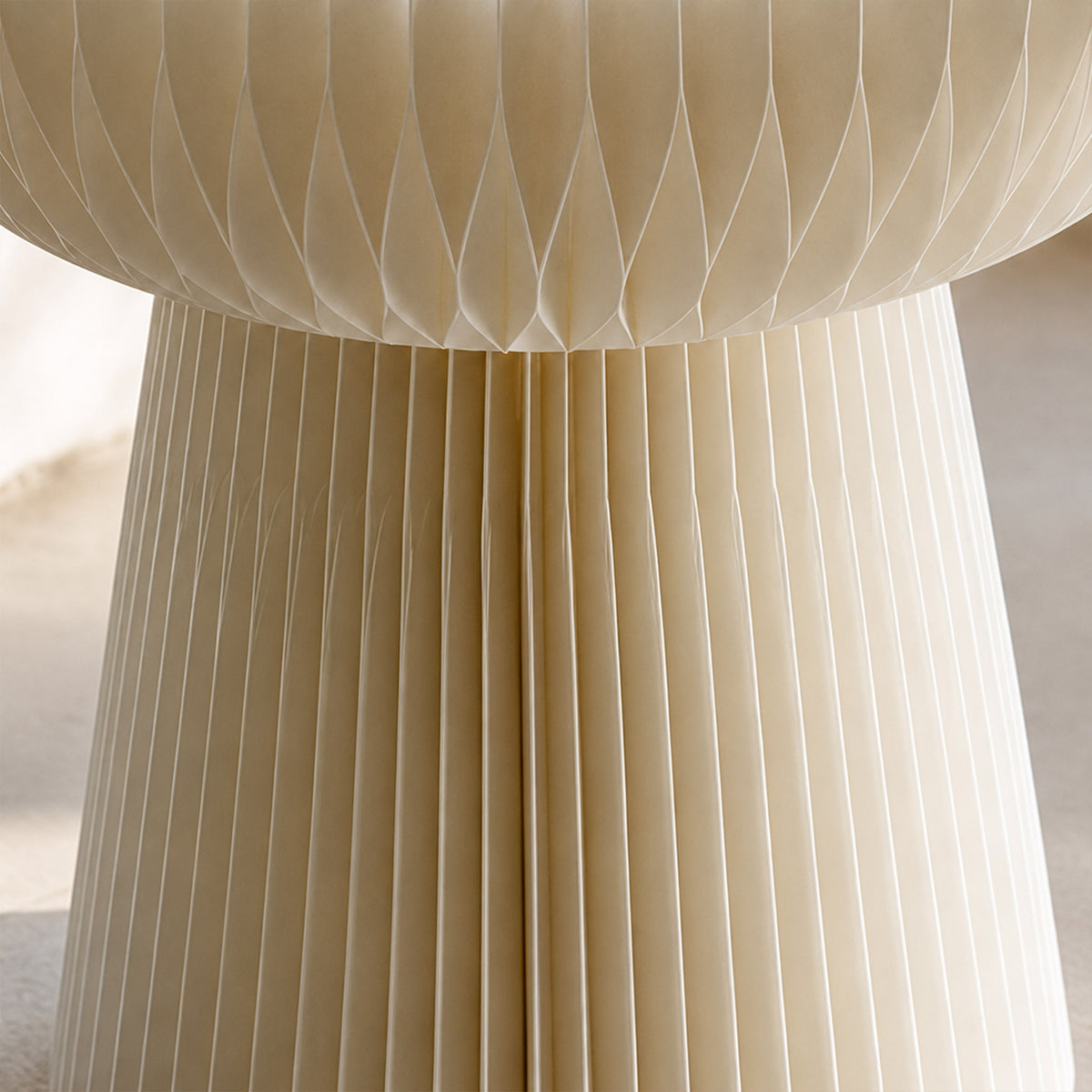 Close-up of the white Bouquet Side Table B showing its folded honeycomb paper structure and sculptural pleats.