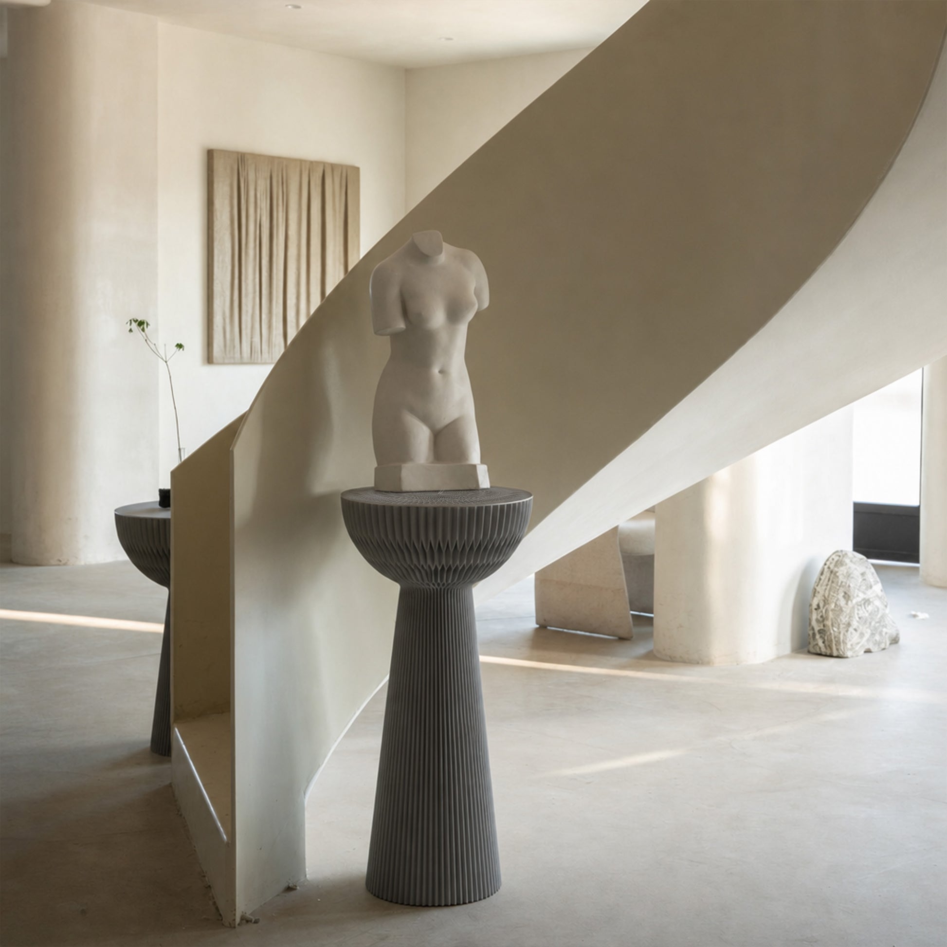 Grey Bouquet Side Table C styled as a tall decorative pedestal with a sculpture in a minimalist interior.