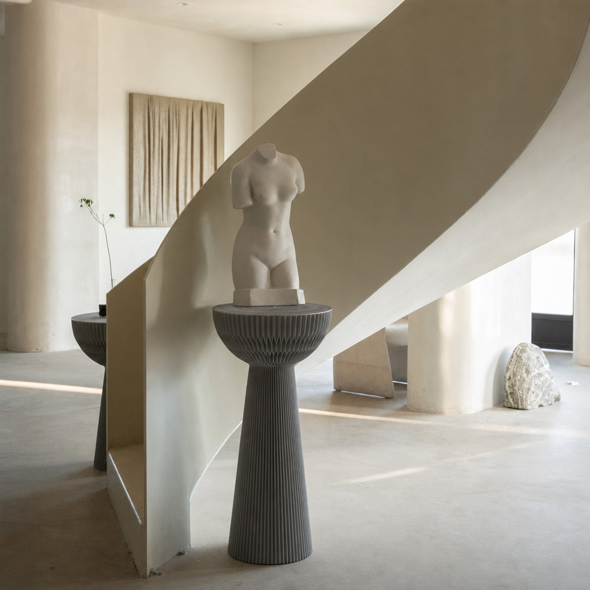 Grey Bouquet Side Table C styled as a tall decorative pedestal with a sculpture in a minimalist interior.