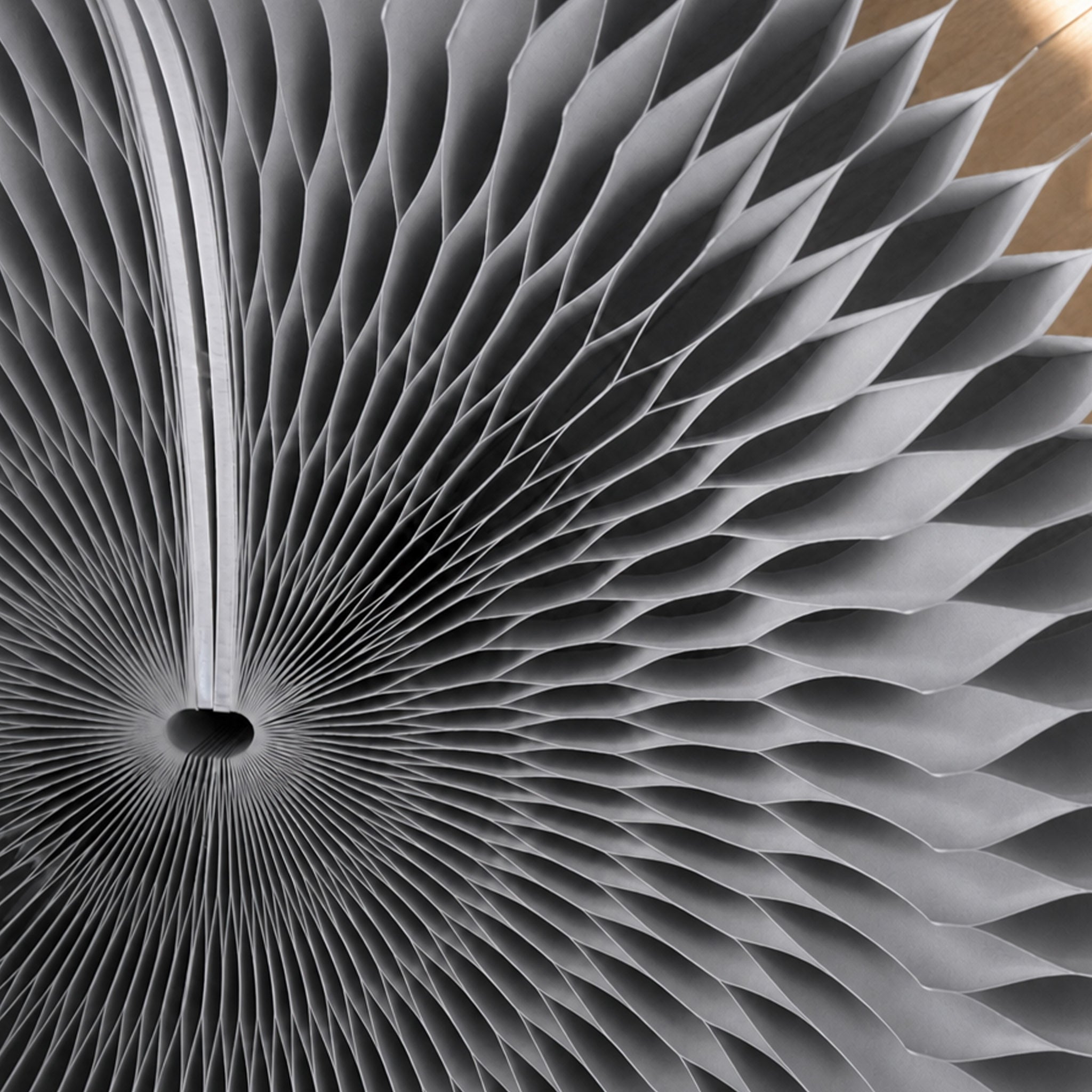 Close-up of the grey Bouquet Side Table C showing the radial honeycomb paper structure and layered folded cells.