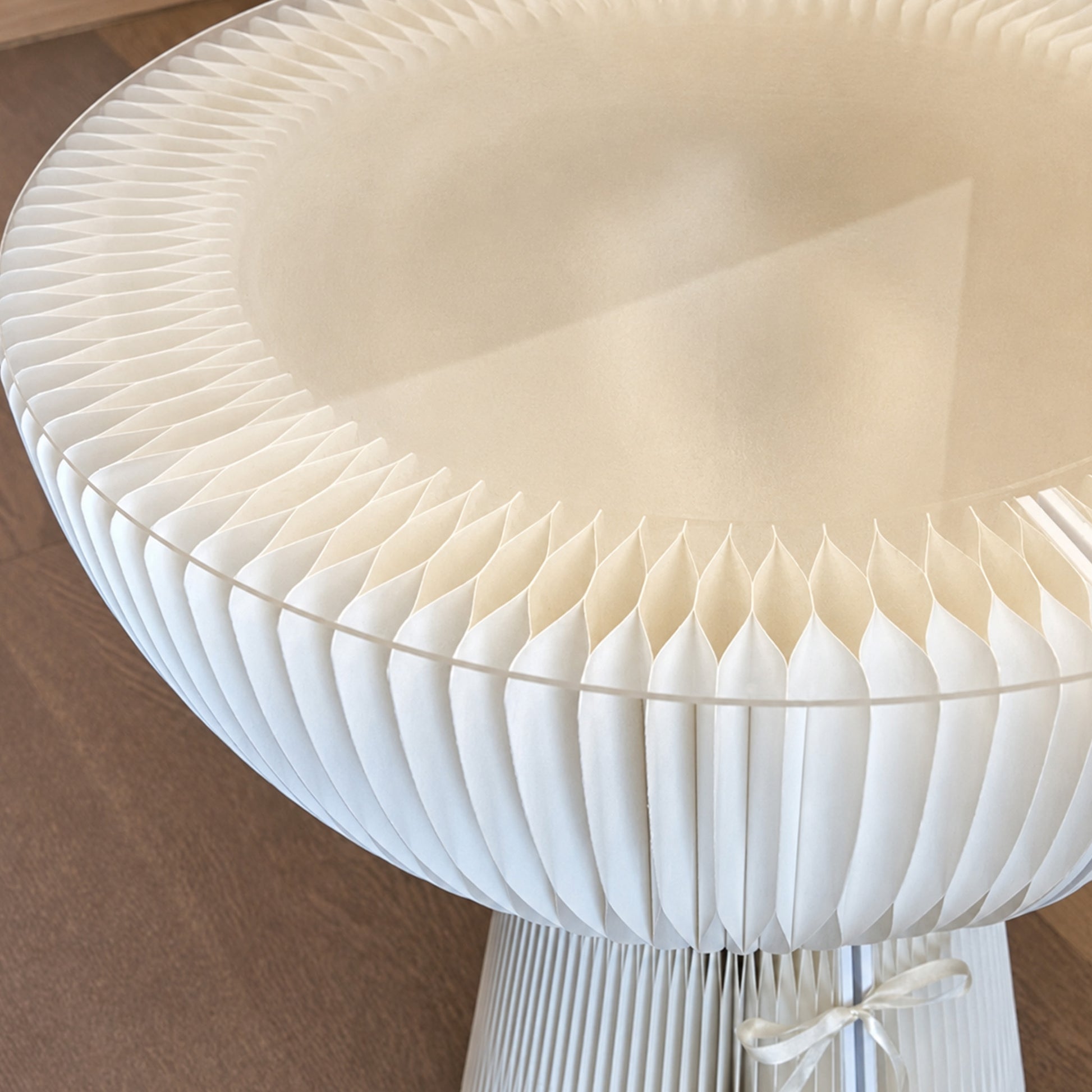 Close-up of the white Bouquet Side Table C showing its layered honeycomb paper structure and clear acrylic edge.