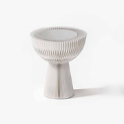Minimalist white bouquet accordion side table featuring a frosted acrylic top for an elegant living room.